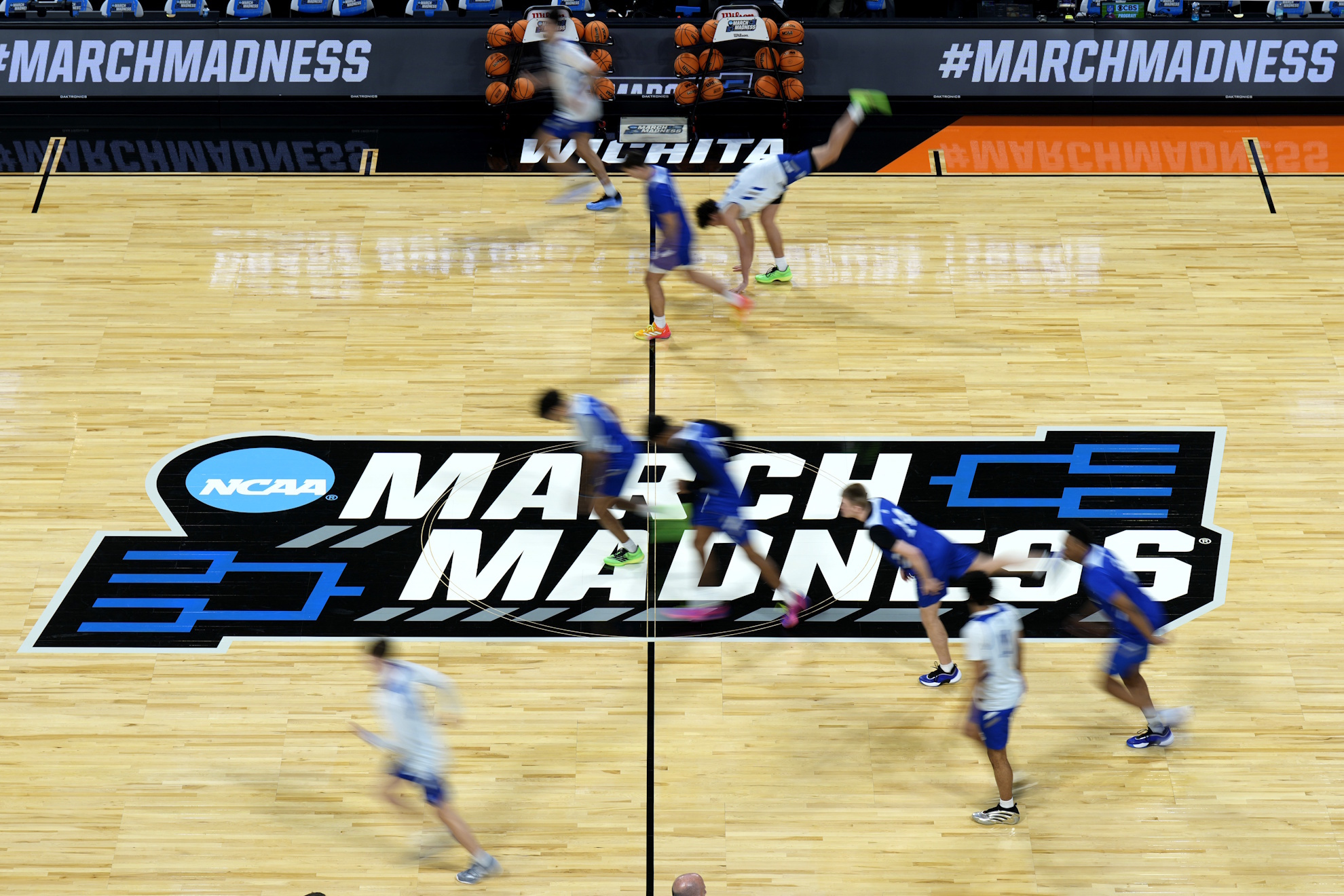 Drake players warm up during practice for the first round of the NCAA college basketball tournament.