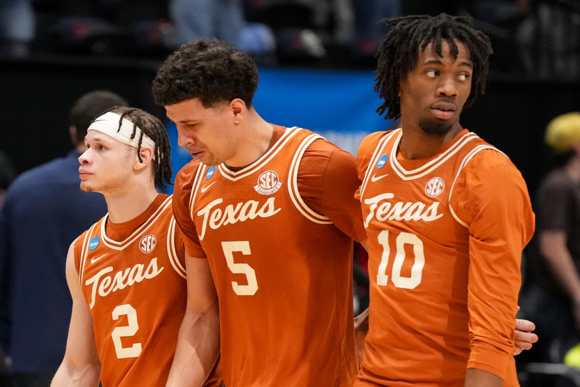 Texas' Kadin Shedrick is consoled by teammates Chendall Weaver and Nic Codie following their loss to Xavier during a First Four college basketball game in the NCAA Tournament.