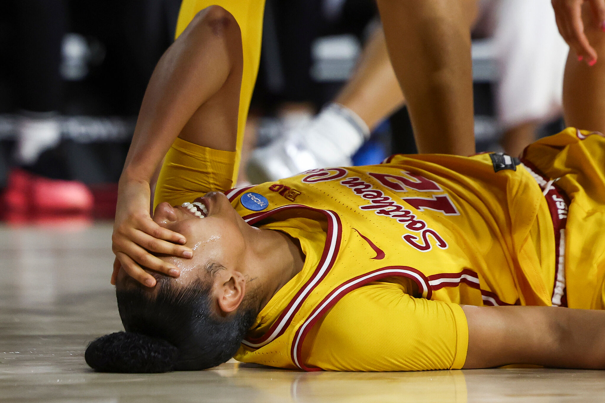 USC guard JuJu Watkins (12) reacts on the floor after an injury against Mississippi State in the second round of March Madness
