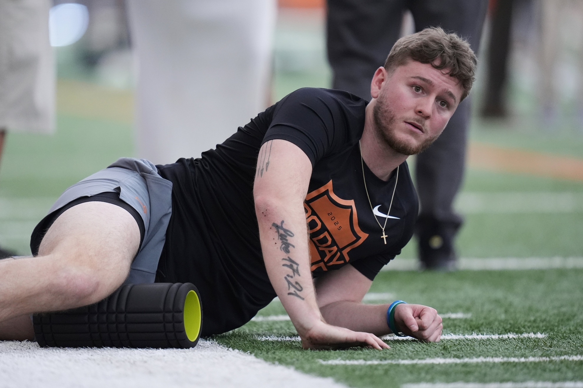 Quinn Ewers stretches during the school's NFL football pro day.