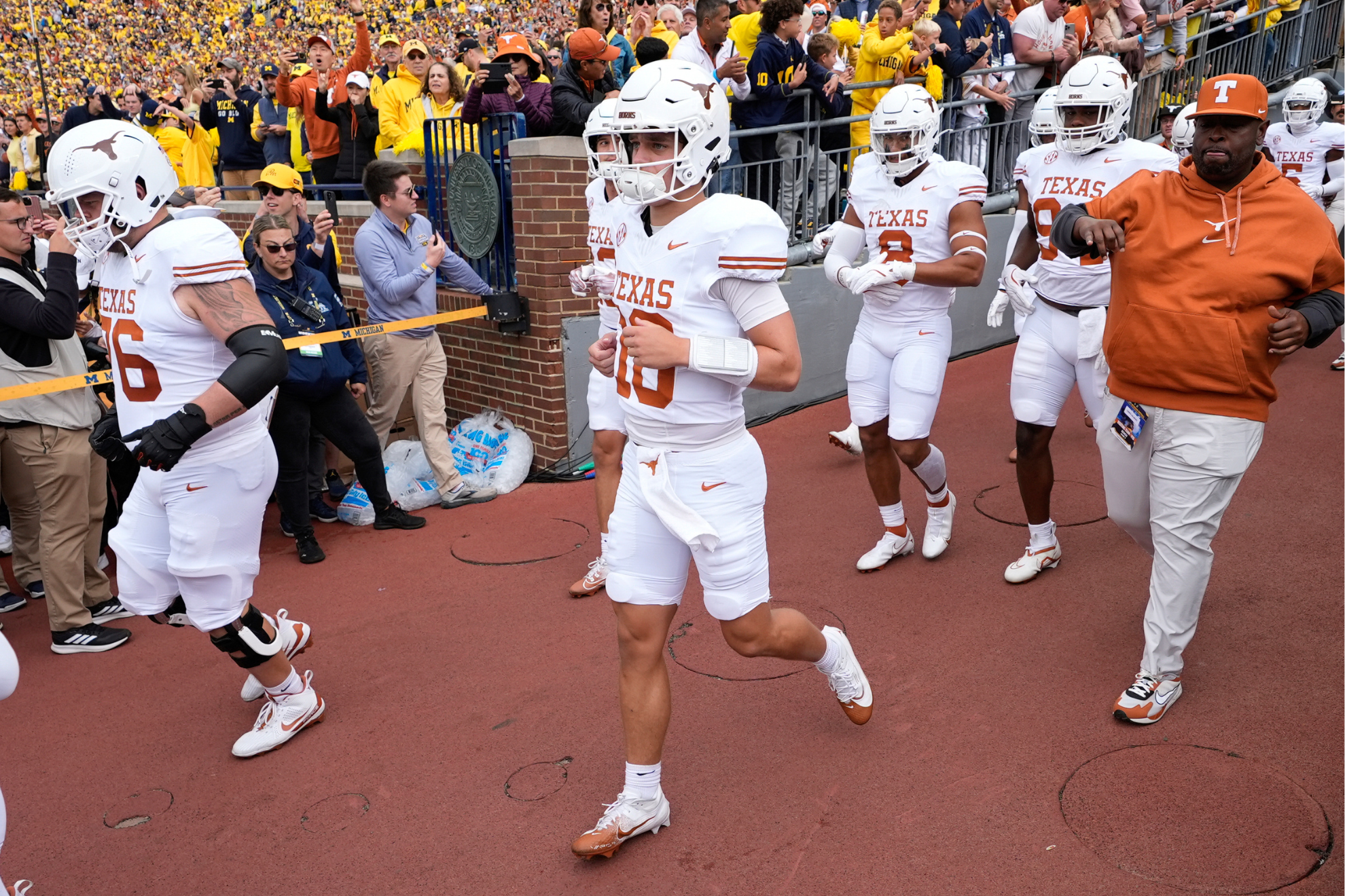 Arch Manning walks out with teammates for the Texas vs. Michigan gamein 2024.