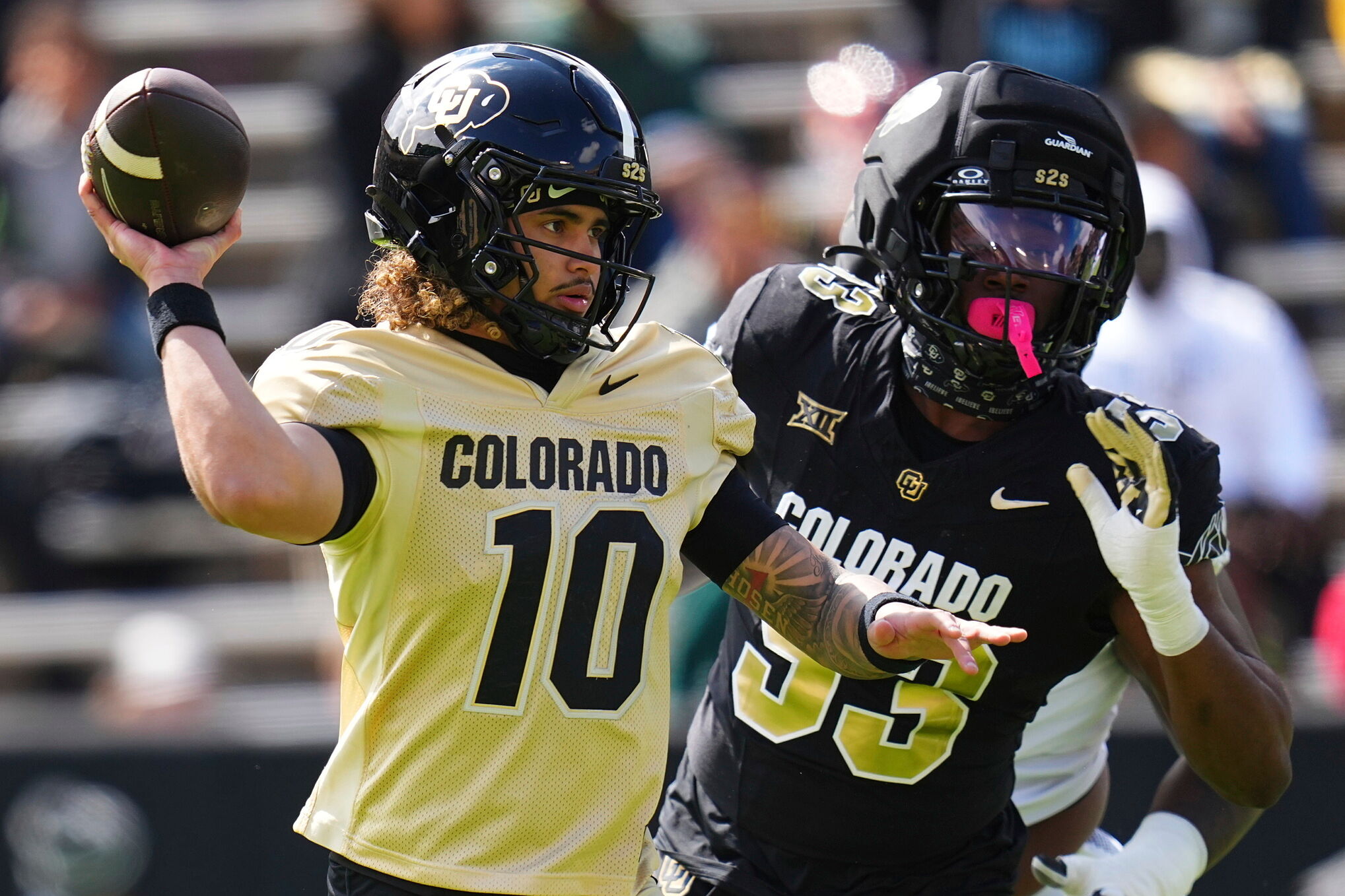 Colorado quarterback Julian Lewis (10) throws under pressure during Colorado's NCAA college football spring game