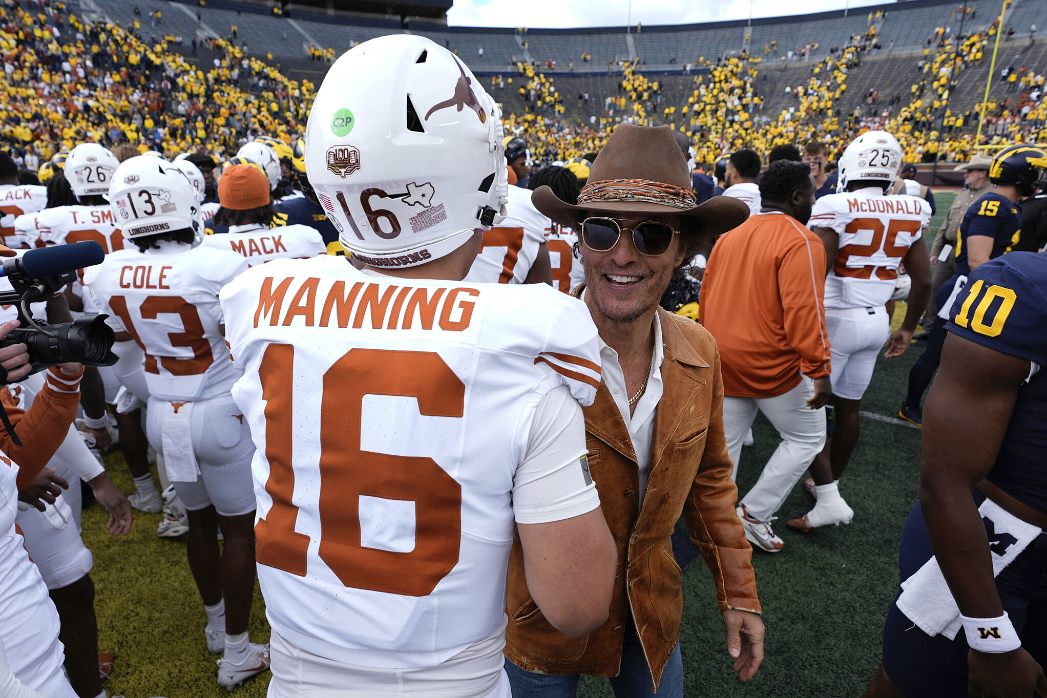 Actor Matthew McConaughey greets Texas quarterback Arch Manning (16) after an NCAA college football game in Ann Arbor, Mich.