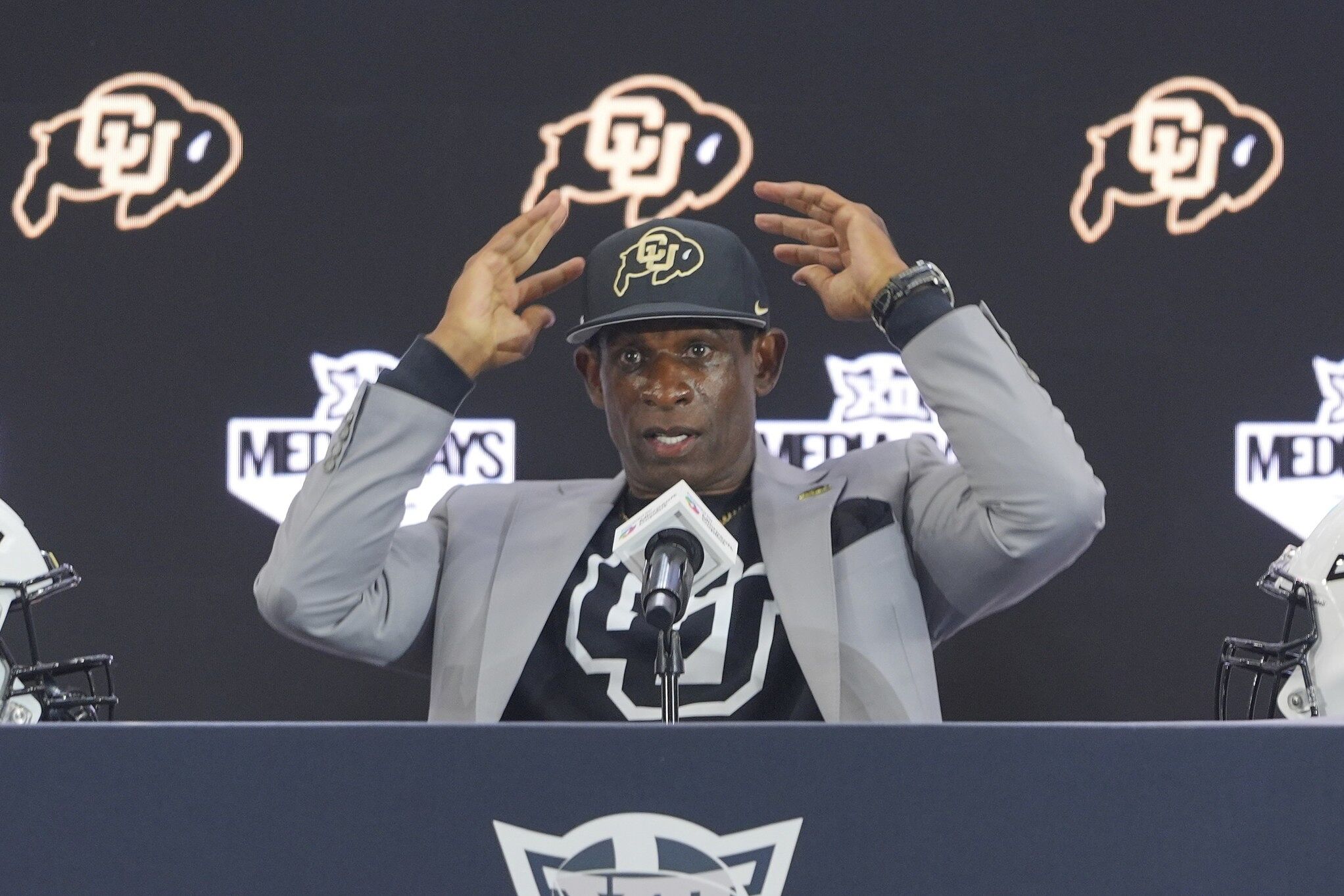 Colorado head coach Deion Sanders gestures after answering questions during the Big 12 NCAA college football media day in Frisco, Texas