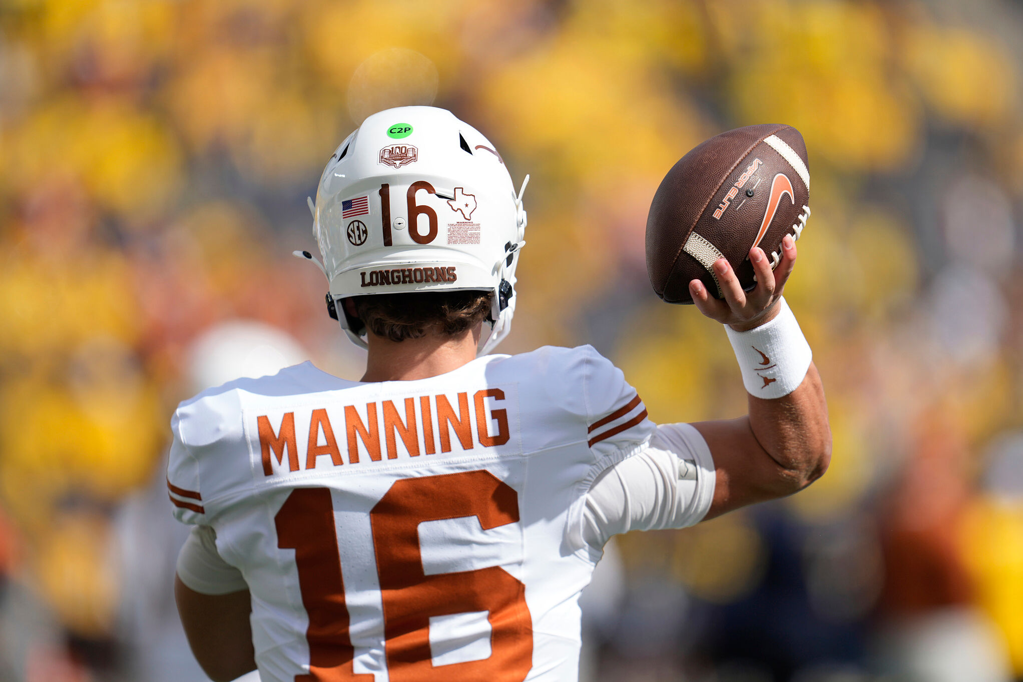 Texas quarterback Arch Manning throws during warmups before an NCAA college football game against Michigan in Ann Arbor