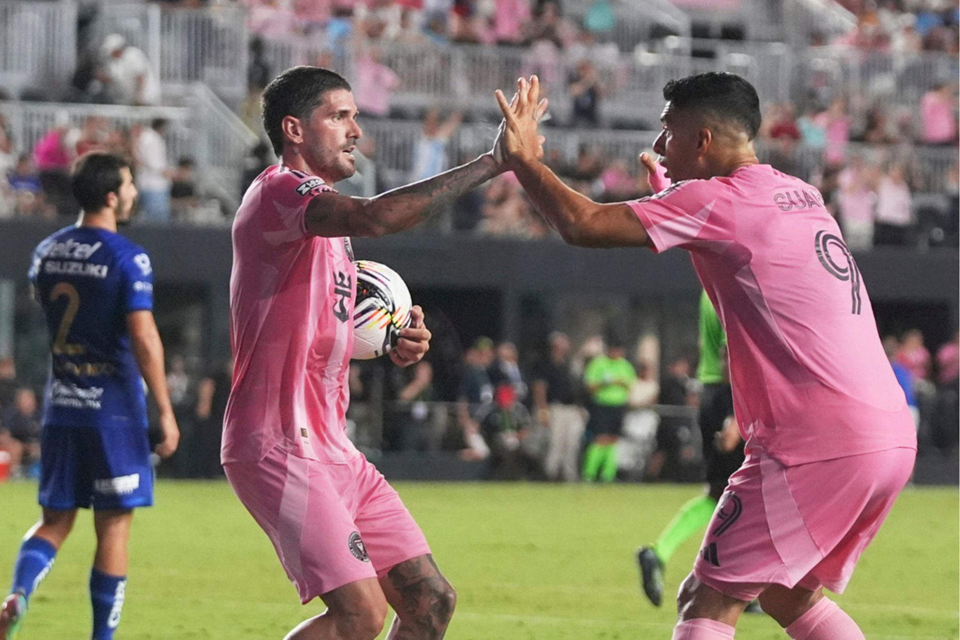 Inter Miami midfielder Rodrigo De Paul, left celebrates with forward Luis Suárez after scoring a goal during the first half of a Leagues Cup soccer match against Puma UNAM