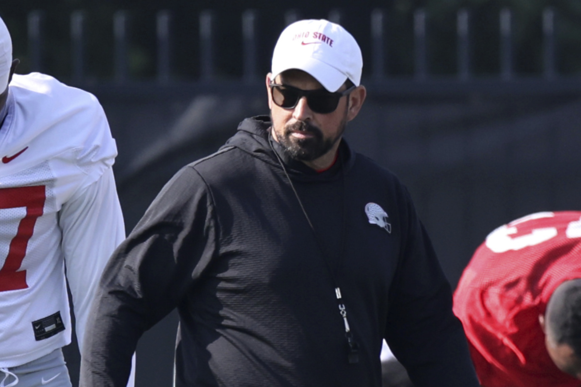 Ohio State coach Ryan Day watches his team stretch during NCAA college football practice in Columbus, Ohio, Friday, Aug. 1, 2025. (AP Photo/Paul Vernon)