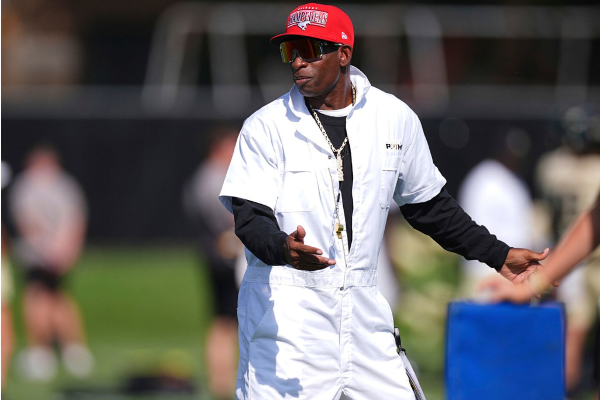 Colorado head coach Deion Sanders looks on as players take part in drills during an NCAA college football practice