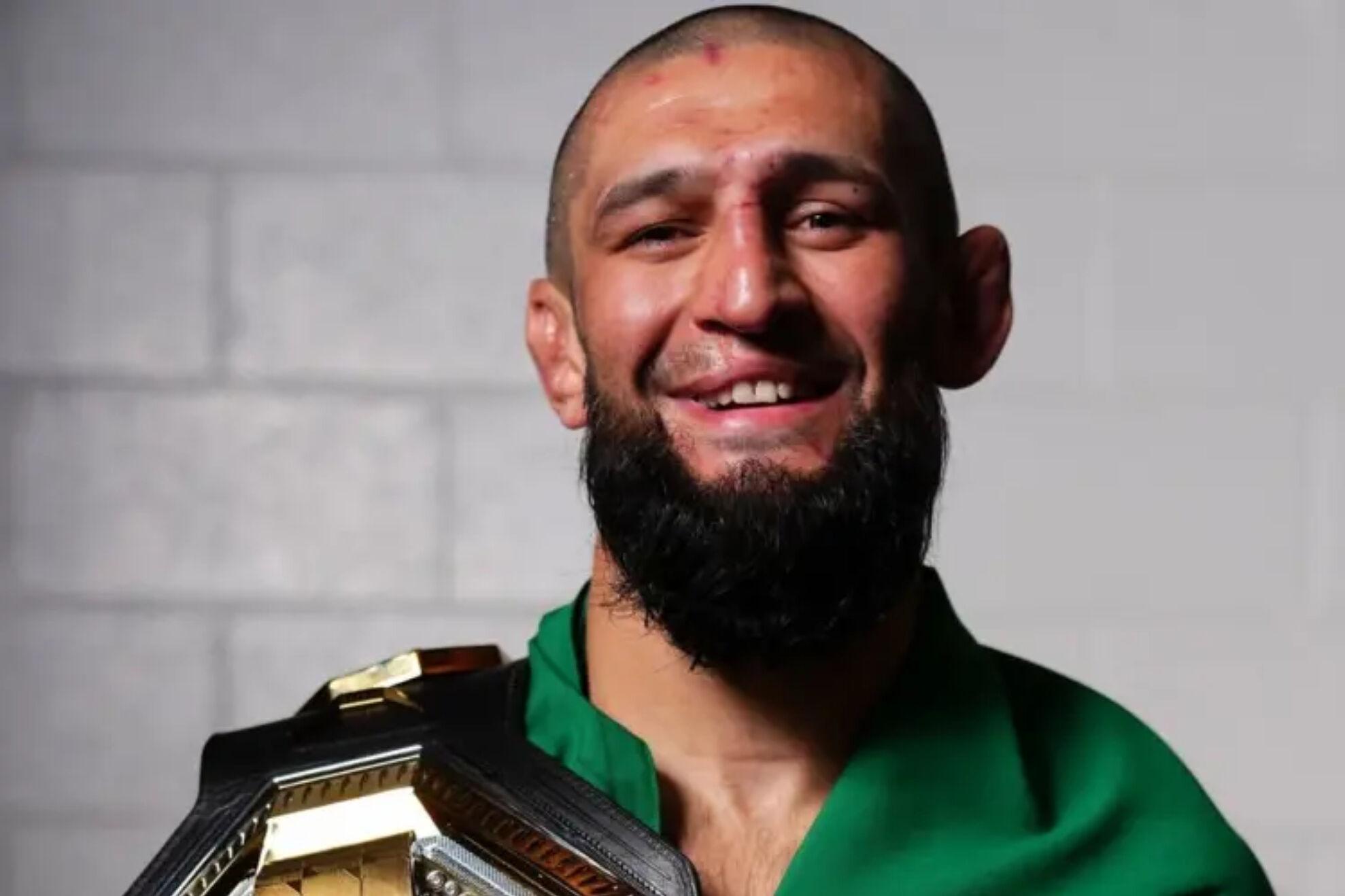 Khamzat Chimaev, posing with the UFC belt.