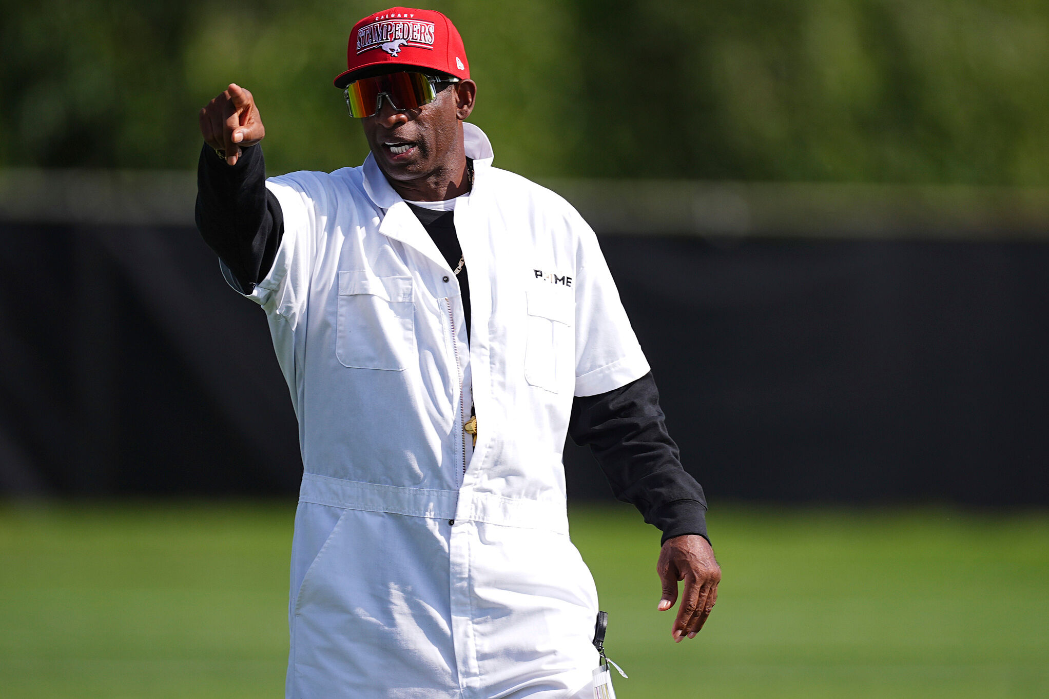 Colorado head coach Deion Sanders looks on as players take part in drills during an NCAA college football practice