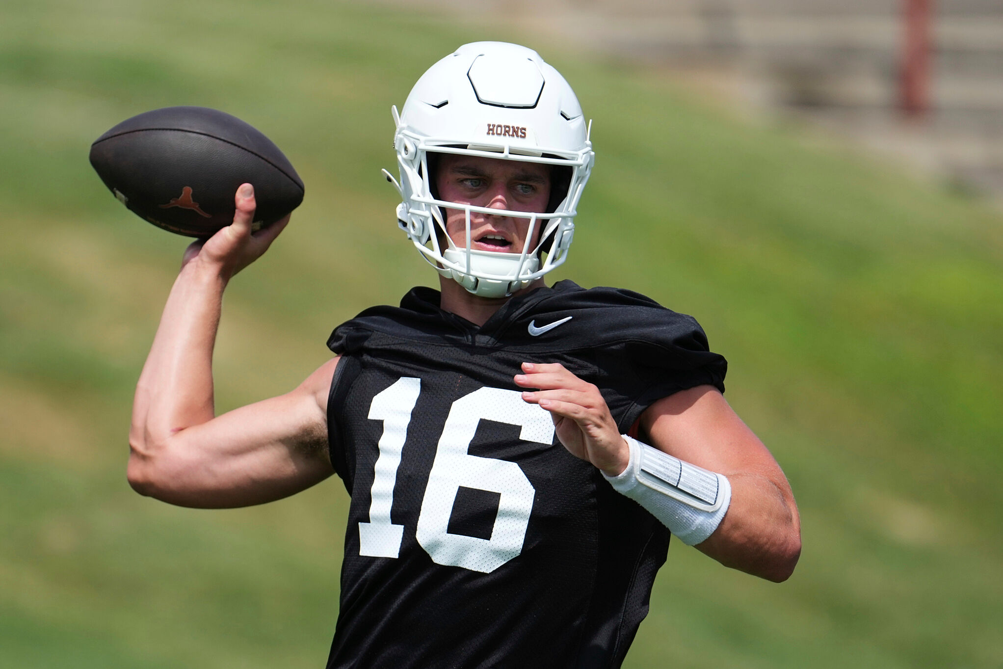 Texas quarterback Arch Manning (16) throws during an NCAA college football practice in Austin, Texas