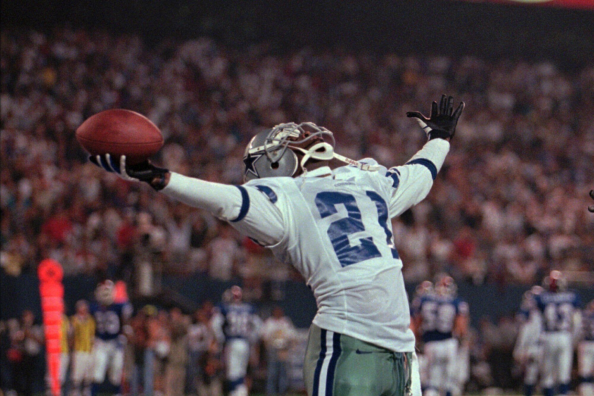 Dallas Cowboys' Deion Sanders plays to the crowd after his 59-yard punt return for a touchdown against the New York Giants Monday, Sept. 21, 1998