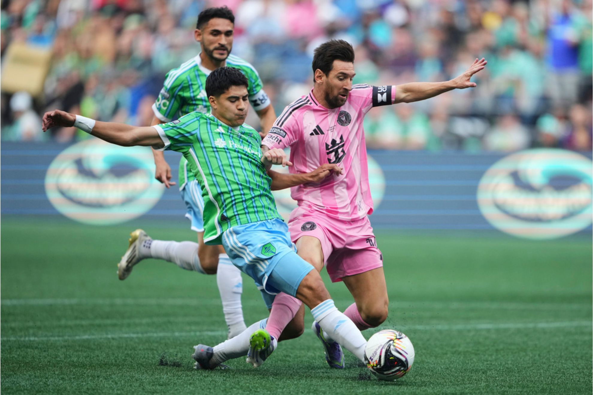 Seattle Sounders midfielder Obed Vargas tackles the ball away from Inter Miami forward Lionel Messi during the first half of a Leagues Cup final soccer match