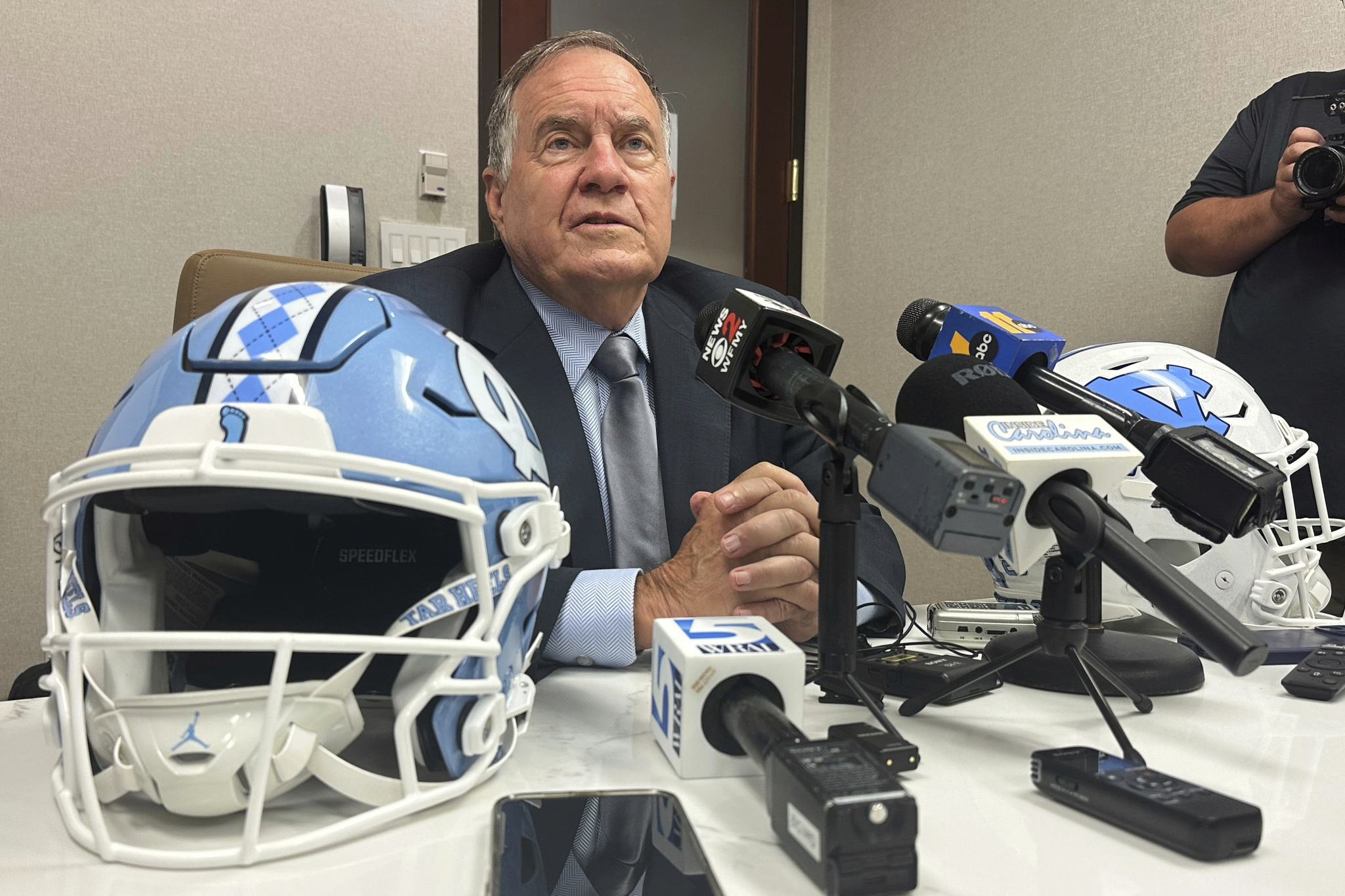 North Carolina coach Bill Belichick speaks with a group of reporters during the Atlantic Coast Conference's NCAA college football media days, Thursday, July 24, 2025, in Charlotte, N.C. (AP Photo/Aaron Beard, File)