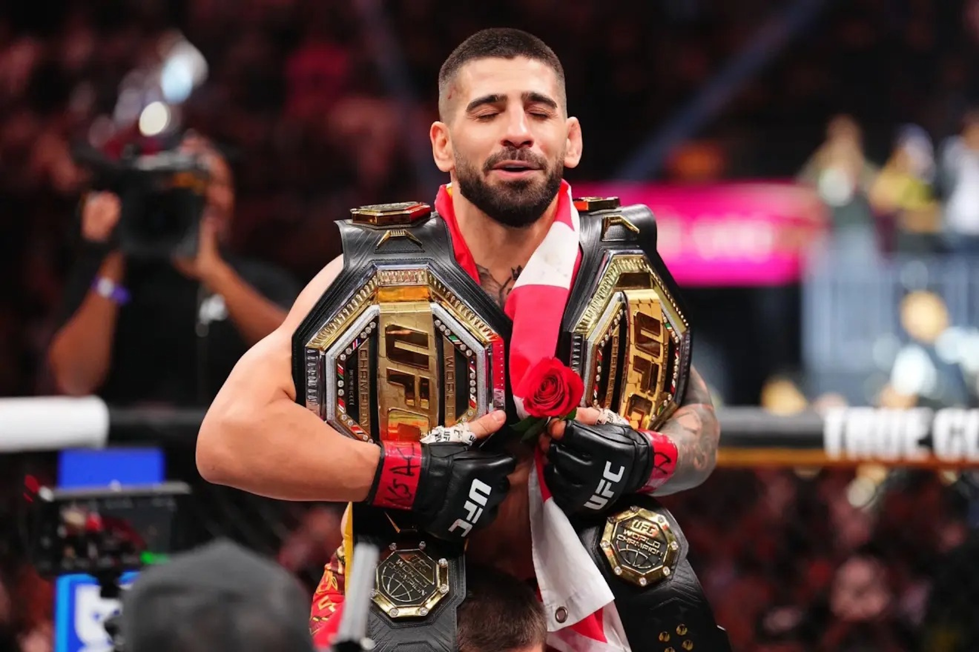 Ilia Topuria celebrates his victory and double belt.