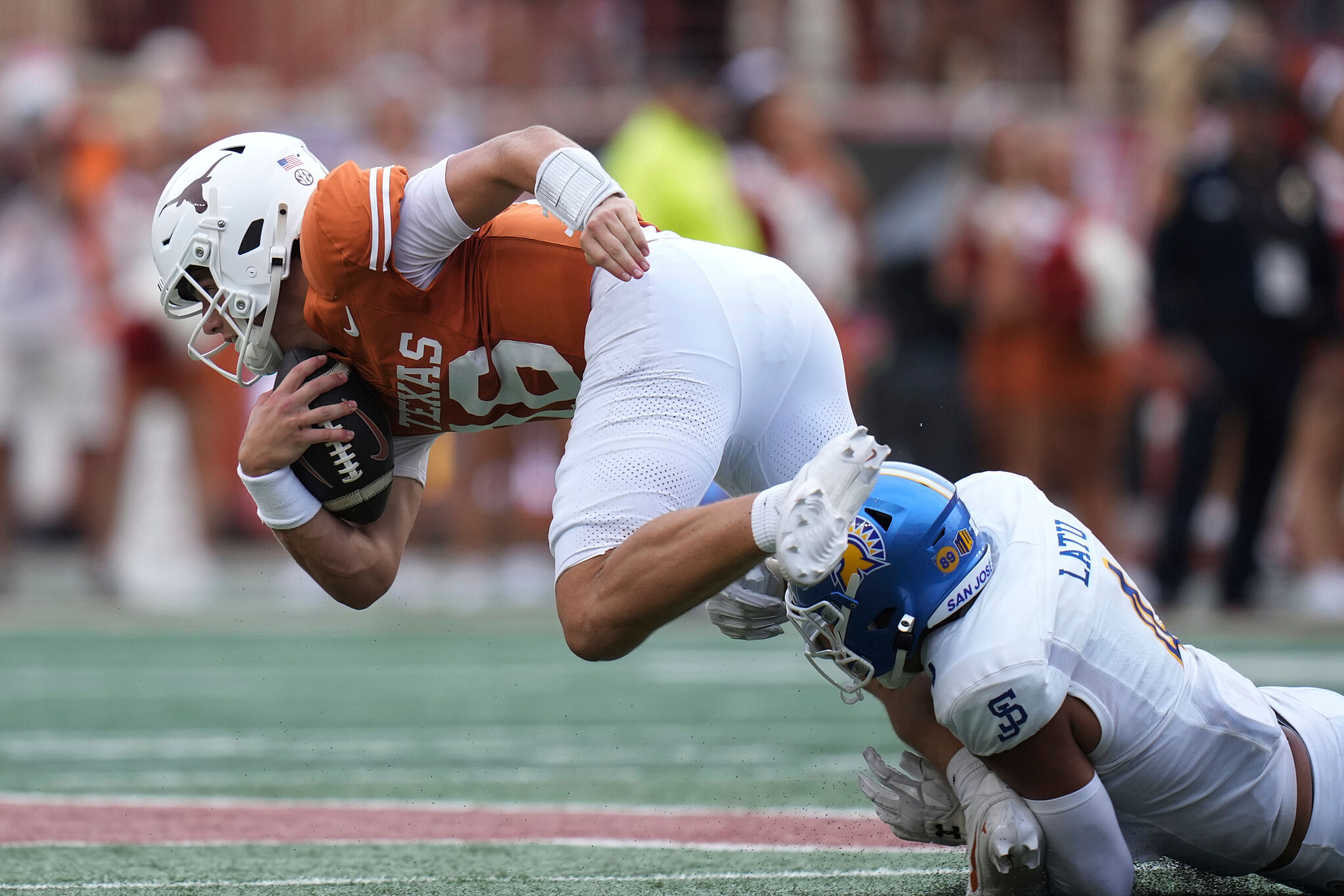 Texas quarterback Arch Manning (16) is stopped by San Jose State linebacker Taniela Latu (4)