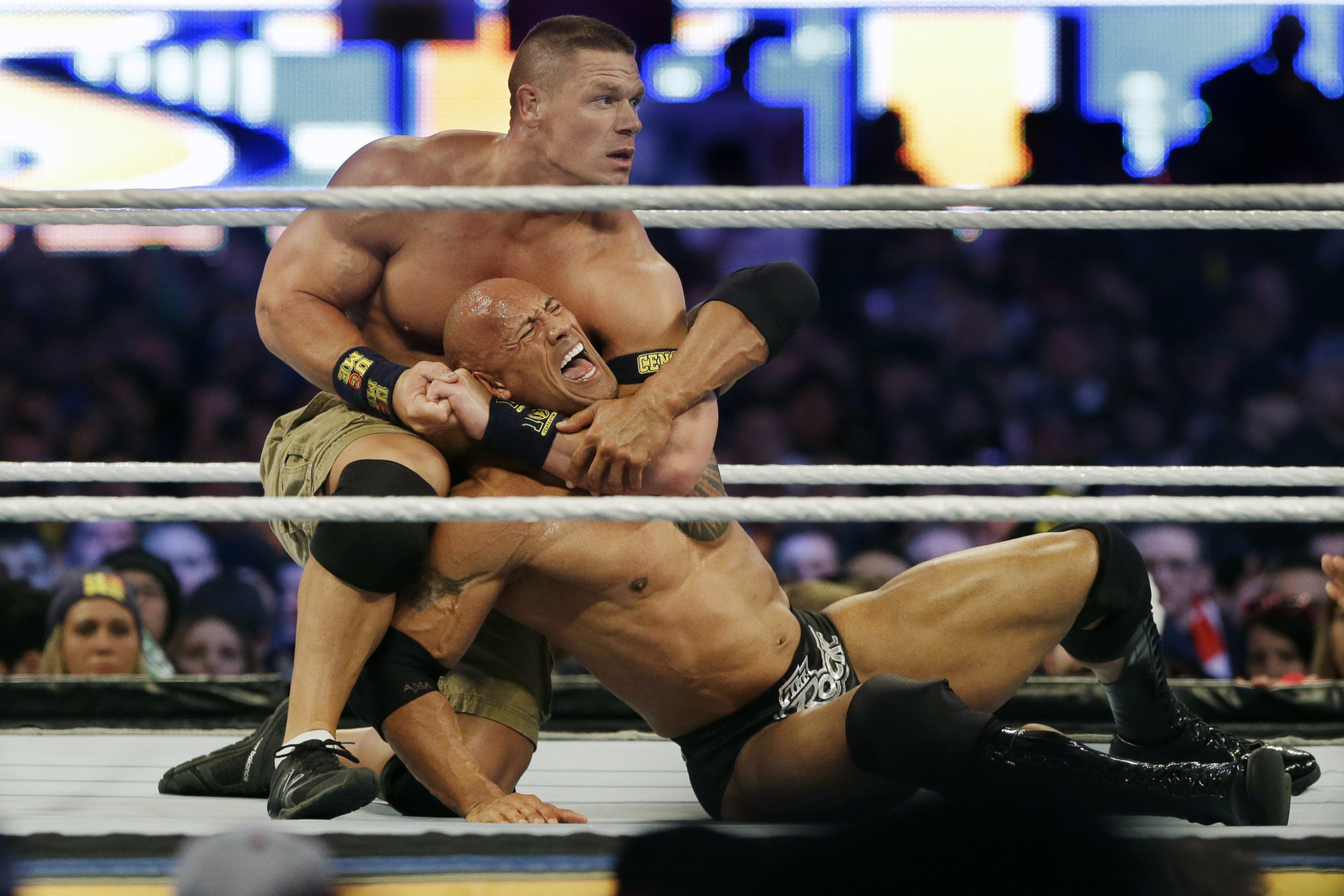John Cena, top, chokes Dwayne "The Rock" Johnson at Wrestlemania on April 7, 2013,