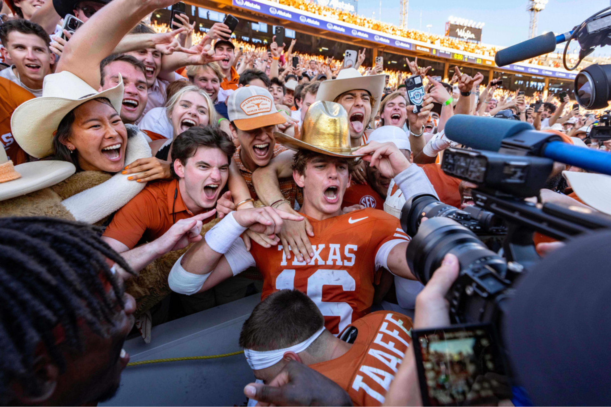 Texas quarterback Arch Manning, center, celebrates with fans after defeating Oklahoma
