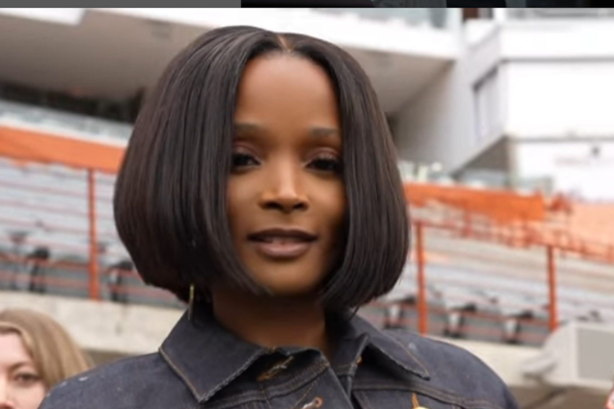 Loreal Sarkisian, wife of Texas Longhorns head coach Steve Sarkisian, wore a sleek black denim emsemble