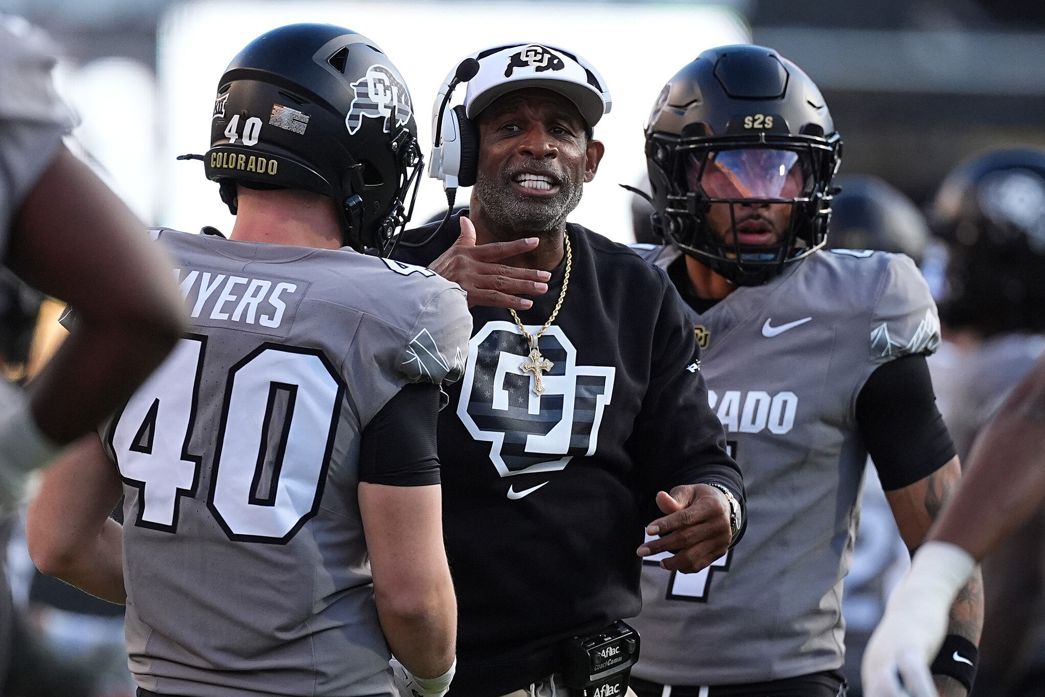 Colorado head coach Deion Sanders confers with linebacker Shaun Myers (40) during an NCAA college football game