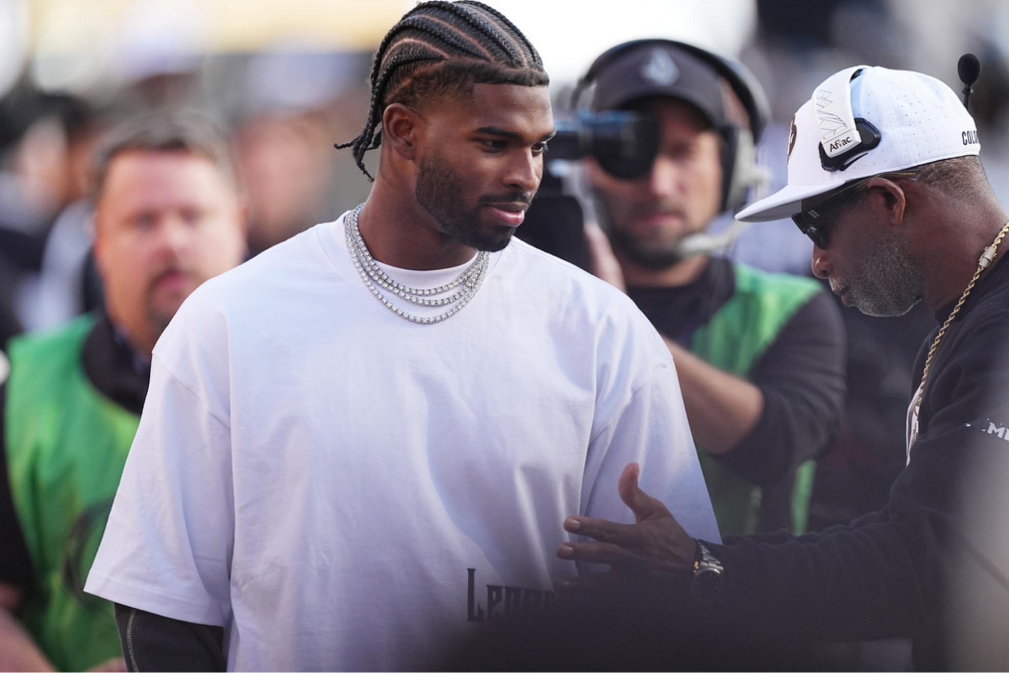 Cleveland Browns quarterback Shedeur Sanders, left, confers with his father, Colorado head coach Deion Sanders,