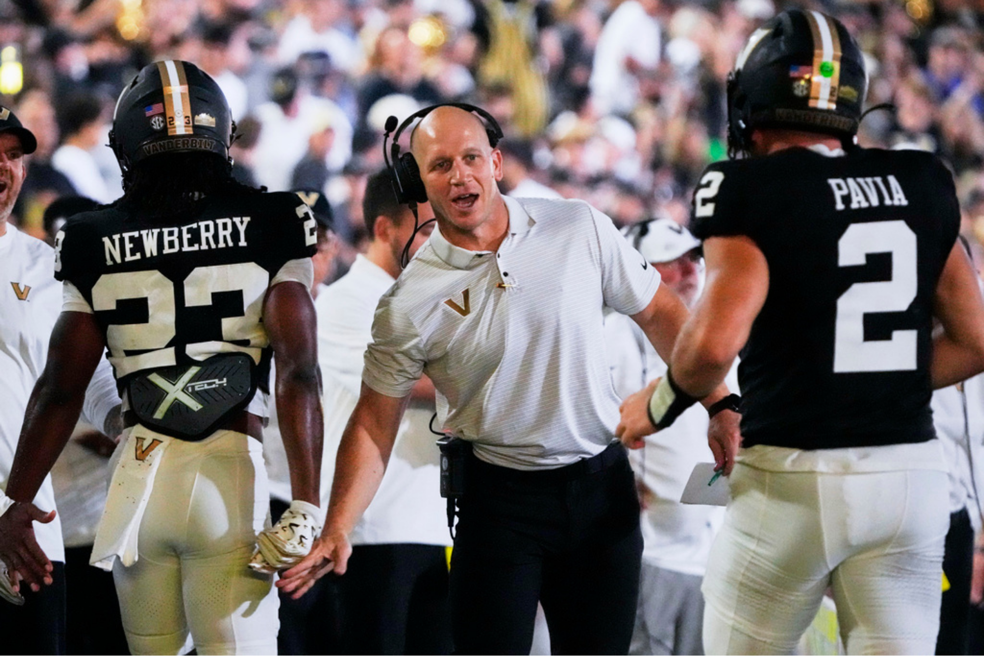 Vanderbilt head coach Clark Lea, center congratulates running back AJ Newberry (23) and quarterback Diego Pavia (2)