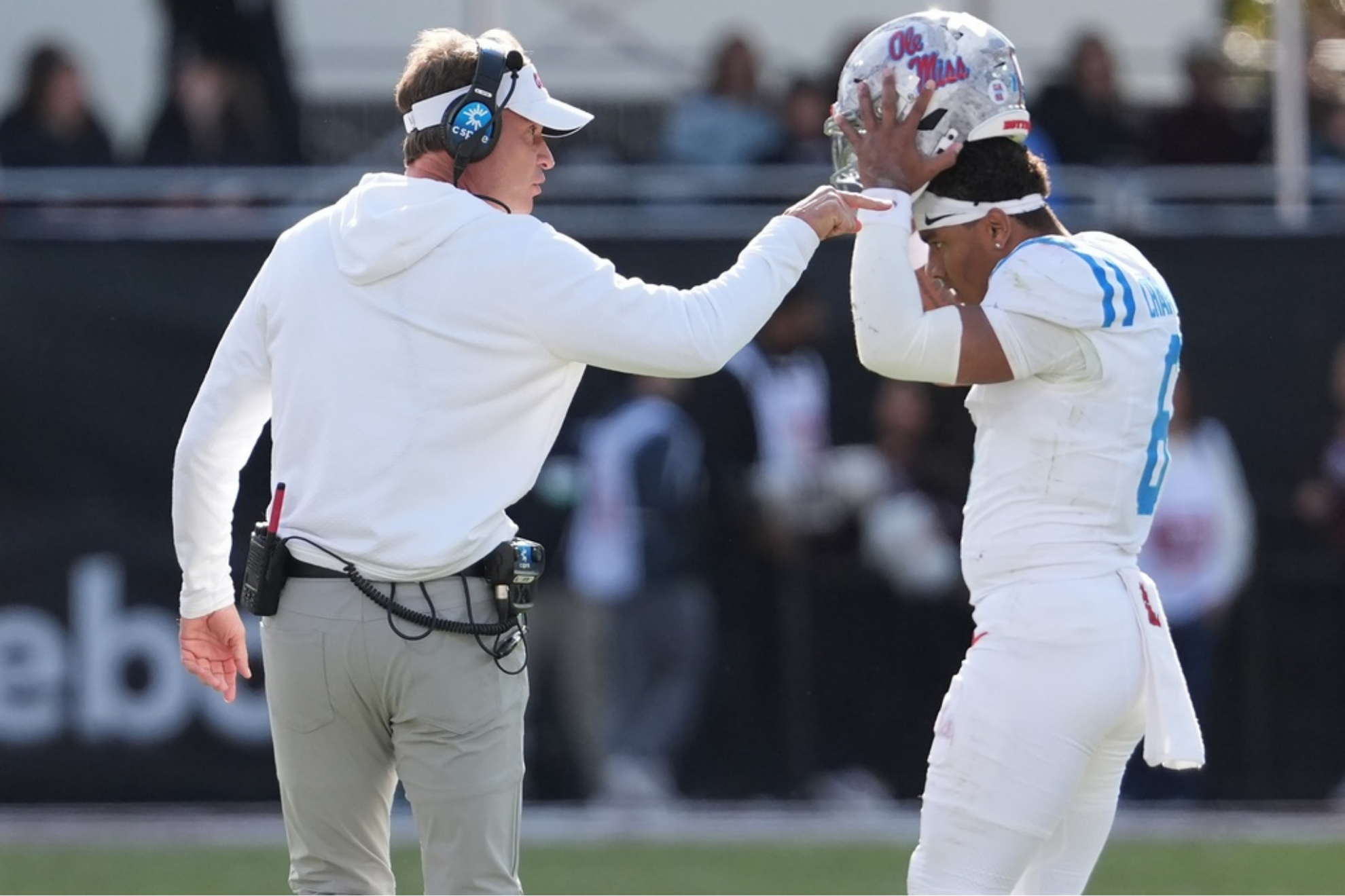 Former Mississippi head coach Lane Kiffin confers with Mississippi quarterback Trinidad Chambliss