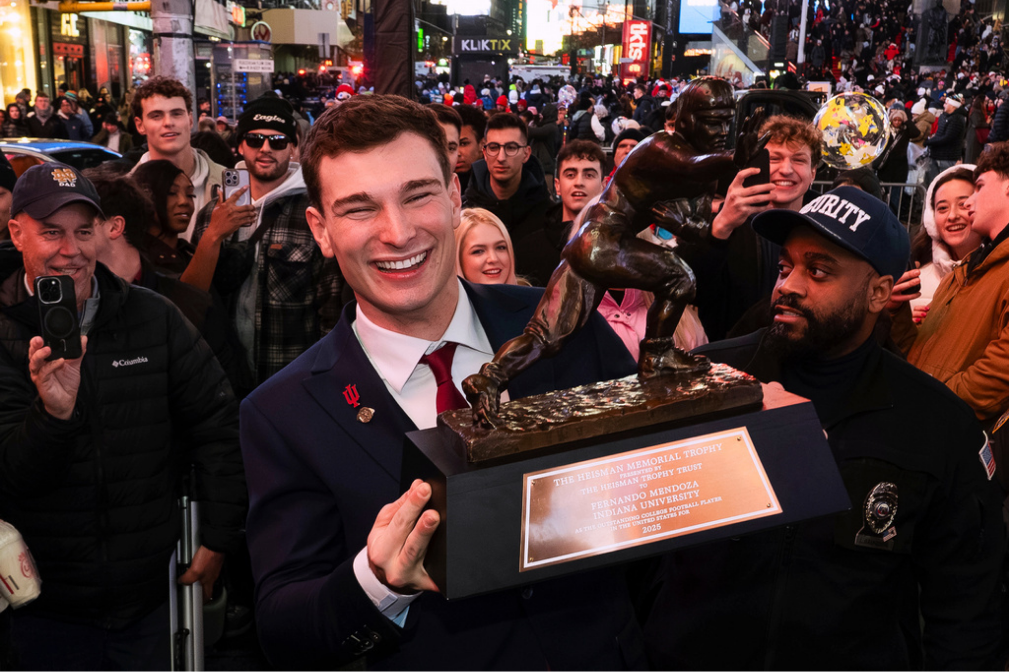 Indiana NCAA college football quarterback Fernando Mendoza celebrates in Times Square after winning the Heisman Trophy