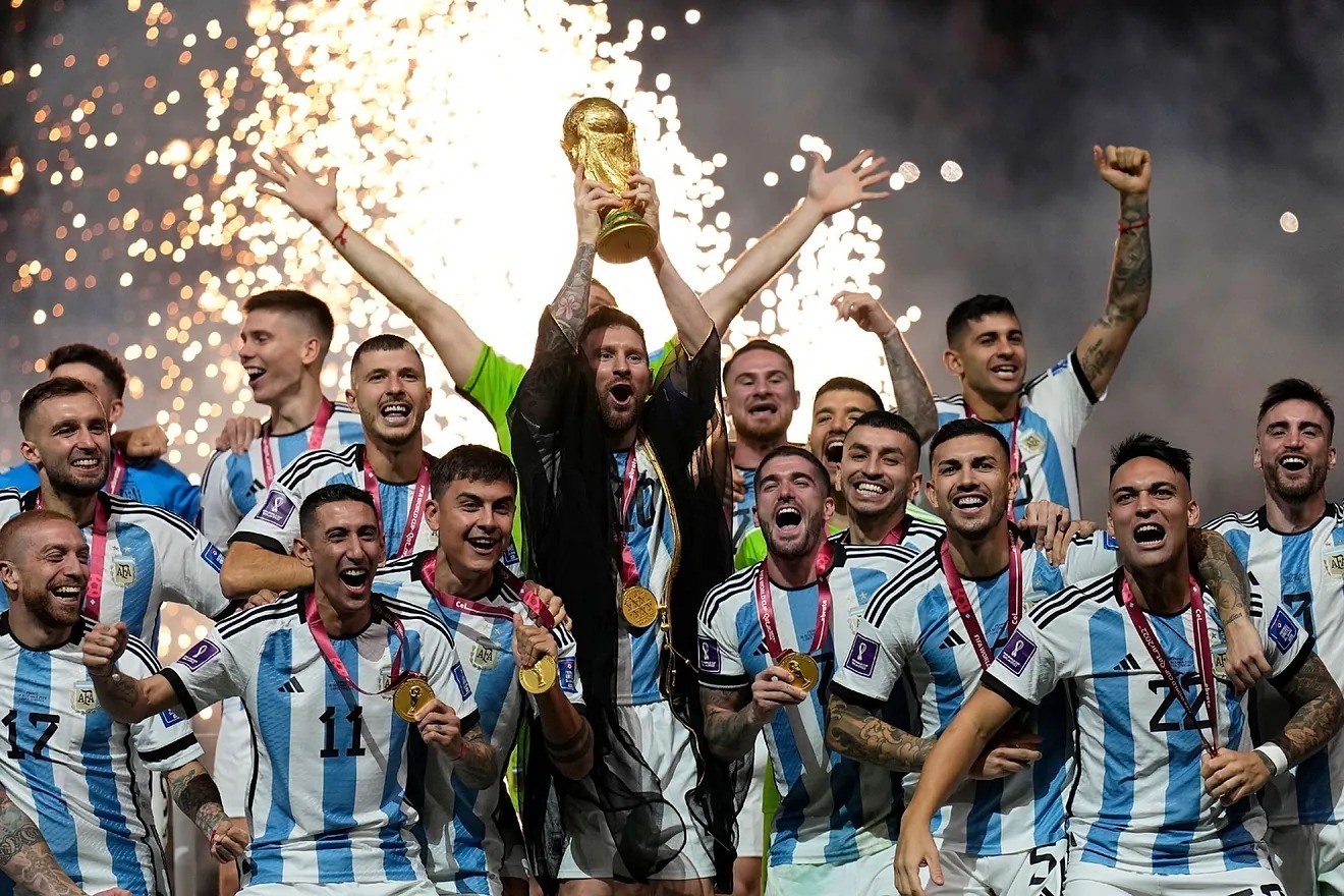 Argentina's Lionel Messi lifts the trophy after winning the World Cup final soccer match.