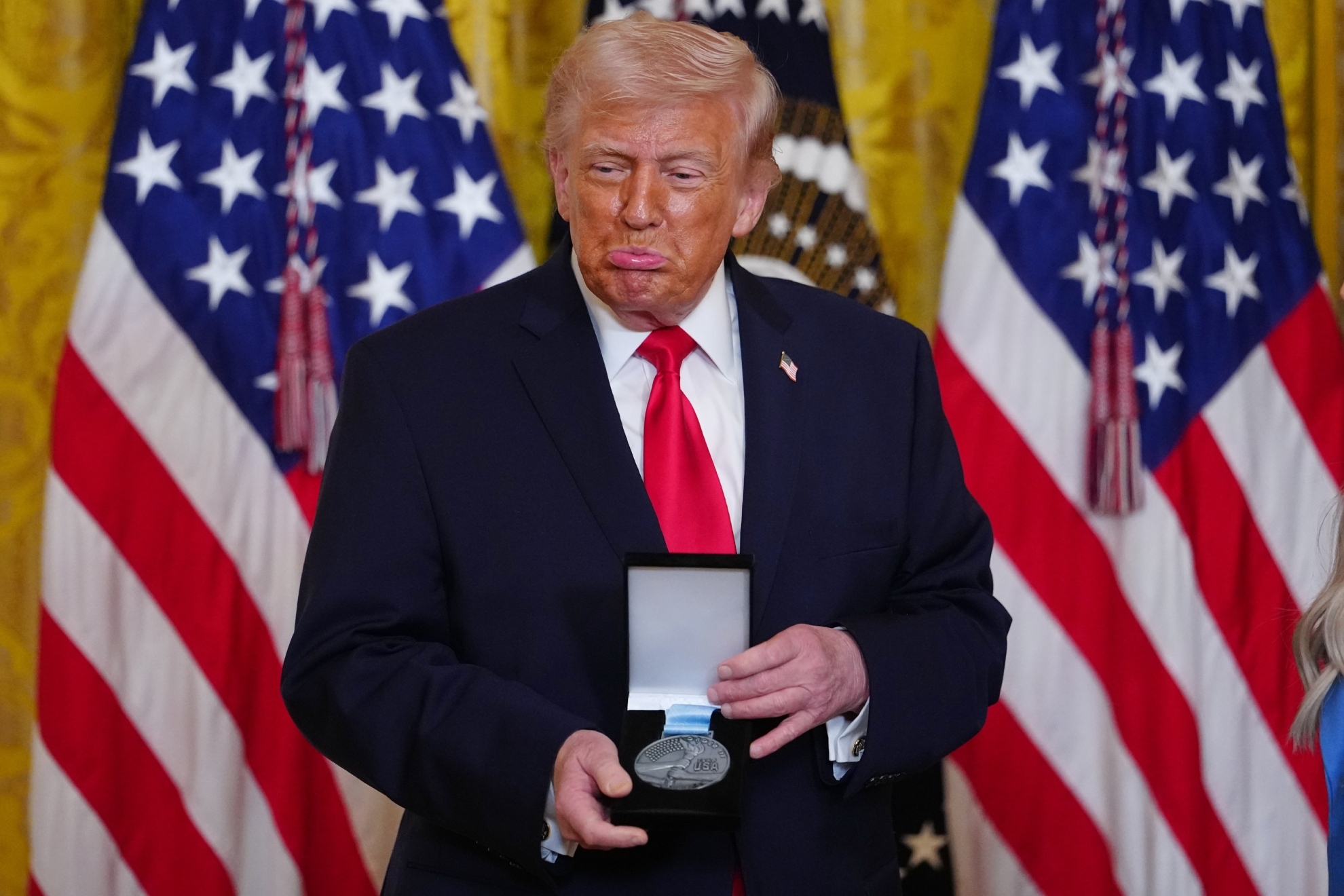 President Donald Trump reacts.