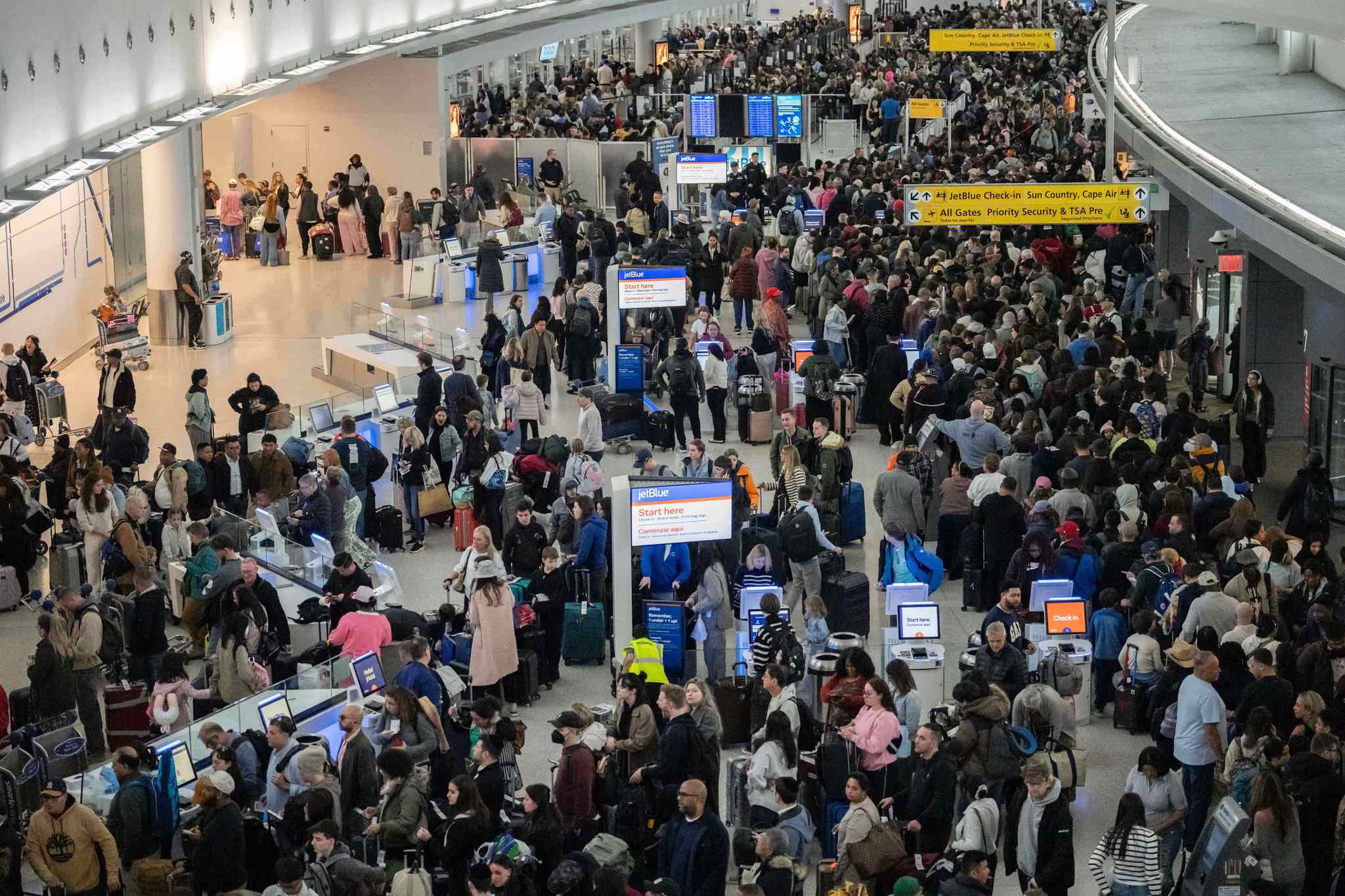 People wait in a TSA line at the John F. Kennedy International Airport in New York, USA