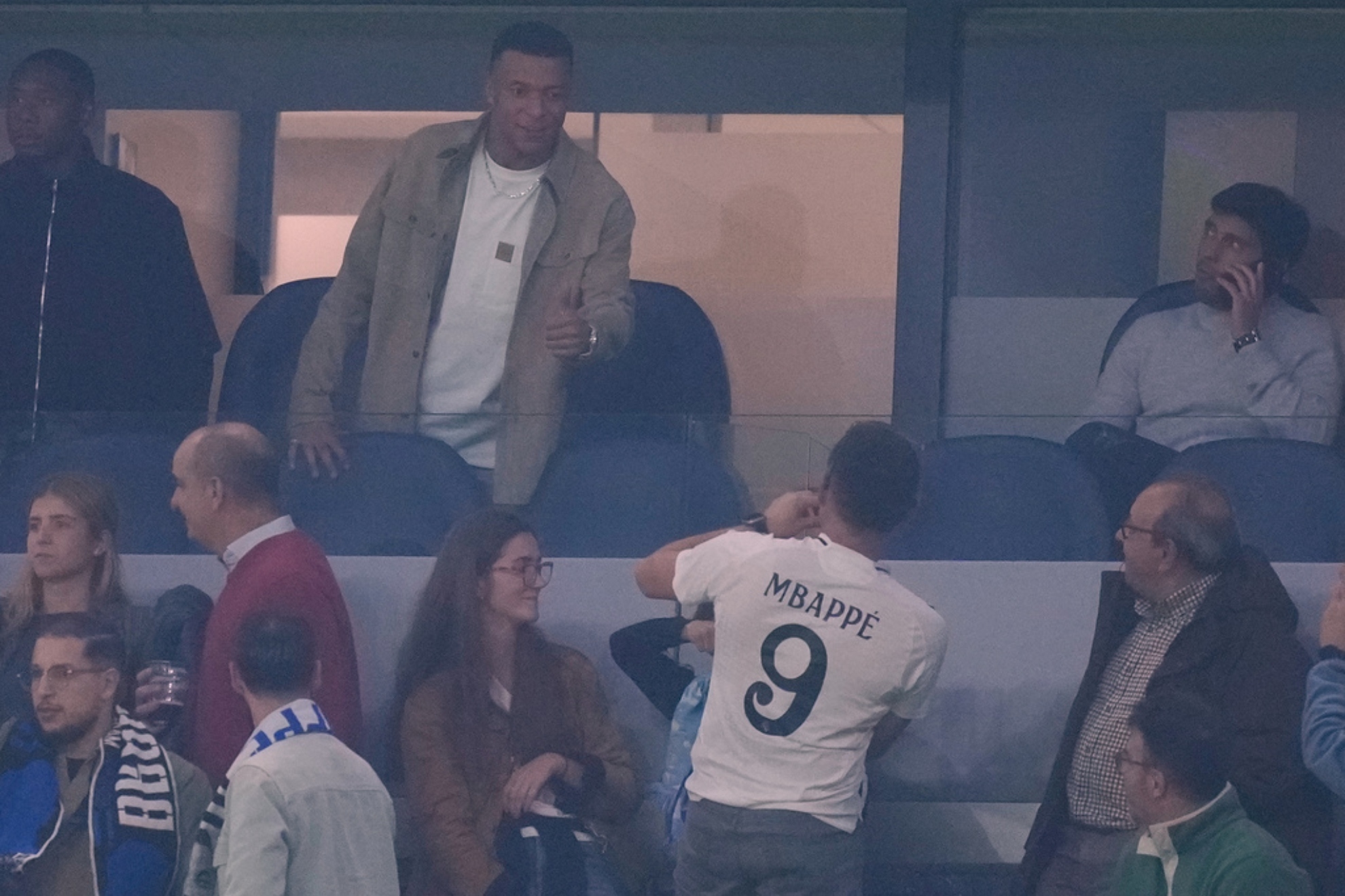 Real Madrid's Kylian Mbappe talks to a fan.