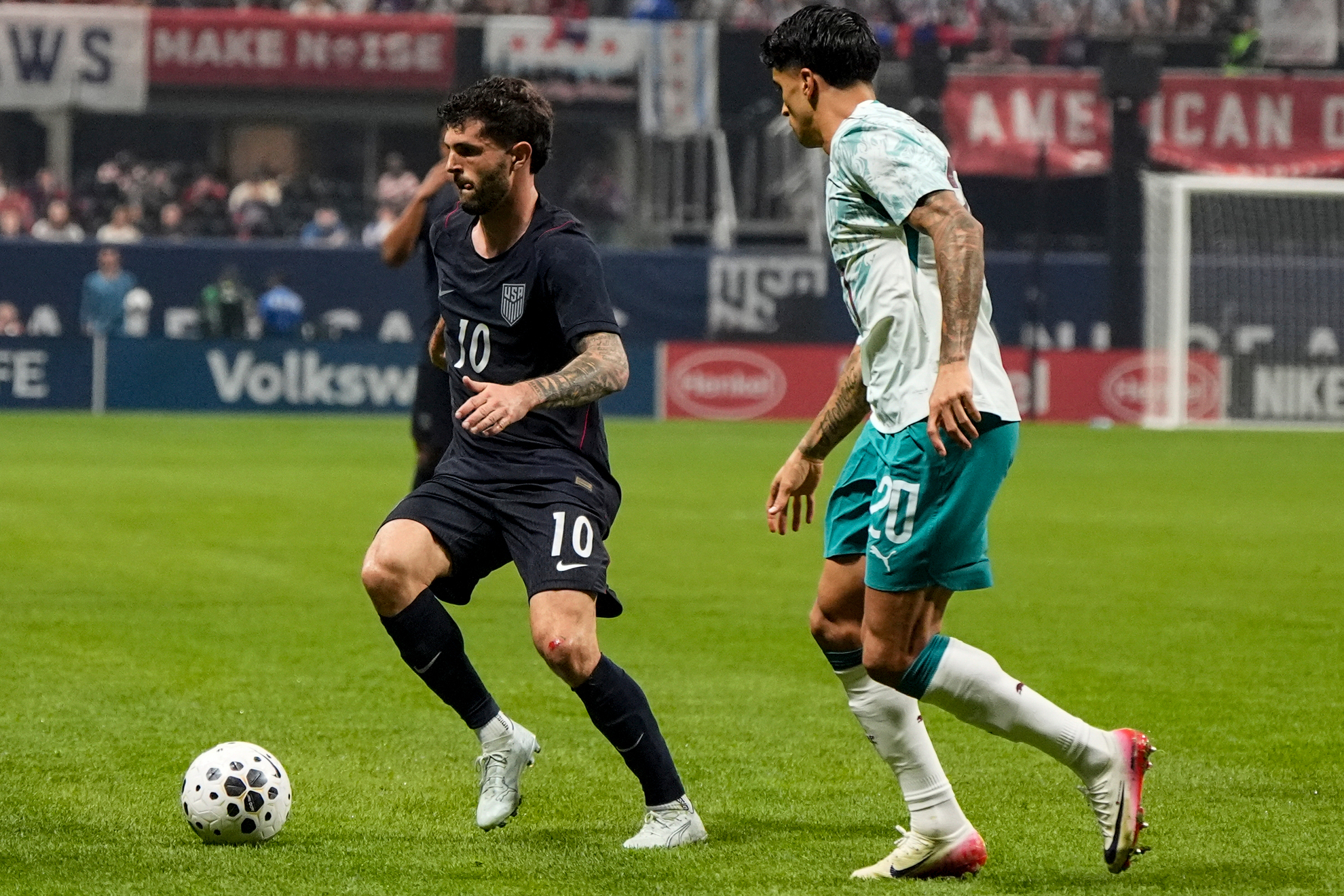 USA's Christian Pulisic moves against Portugal's Joao Cancelo