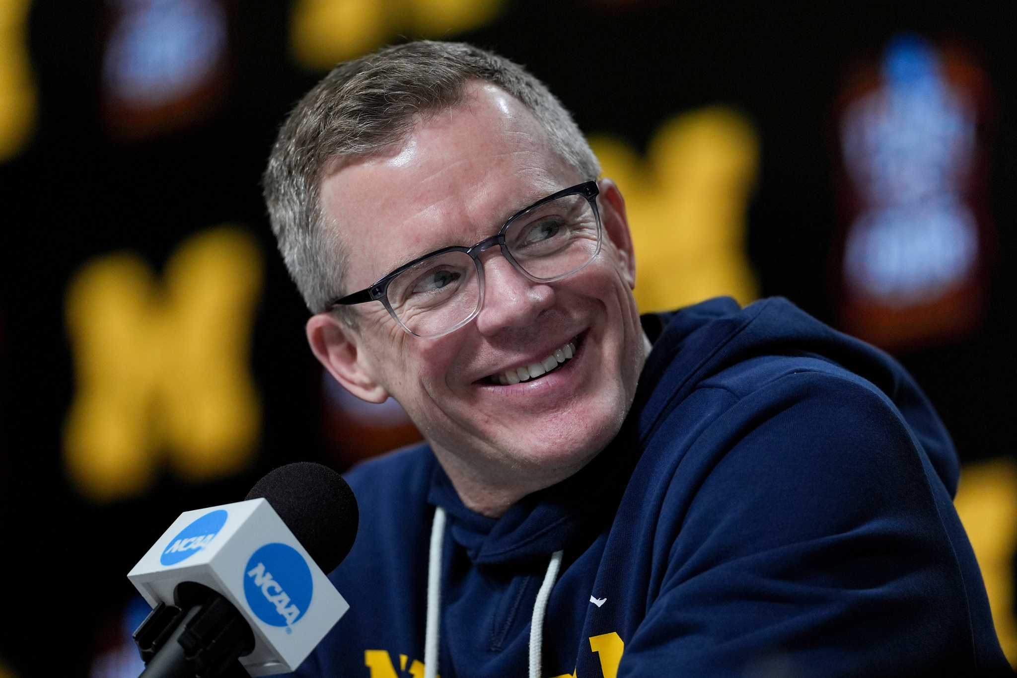 Michigan head coach Dusty May speaks during a news conference ahead of a national championship NCAA college basketball tournament game against UConn