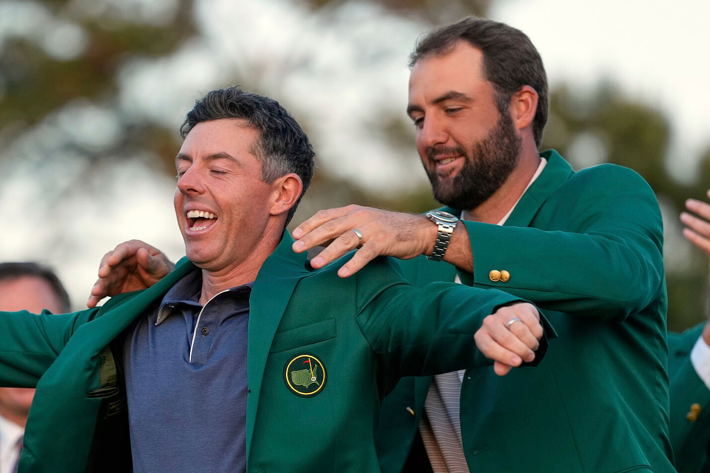 Scottie Scheffler graces Rory McIlroy with the green jacket after the latter won the 2025 Masters Tournament.