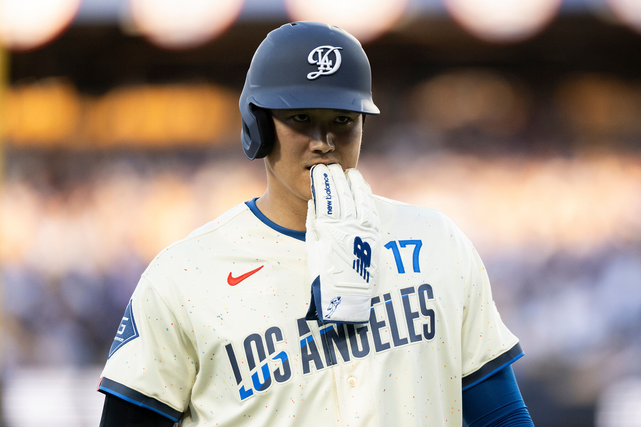 Los Angeles Dodgers' Shohei Ohtani walks back to the dugout during the second inning of a baseball game against the Texas Rangers in Los Angeles