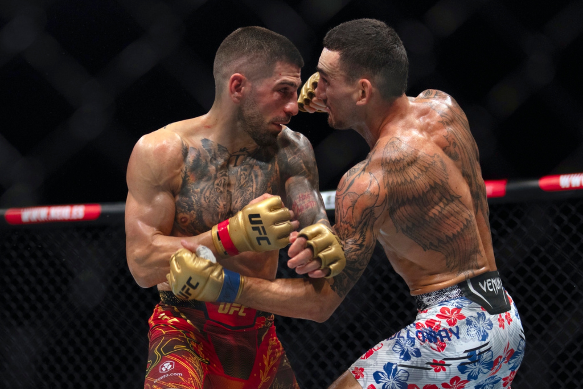Topuria, left, battles Max Holloway during a mixed martial arts featherweight title bout at UFC.