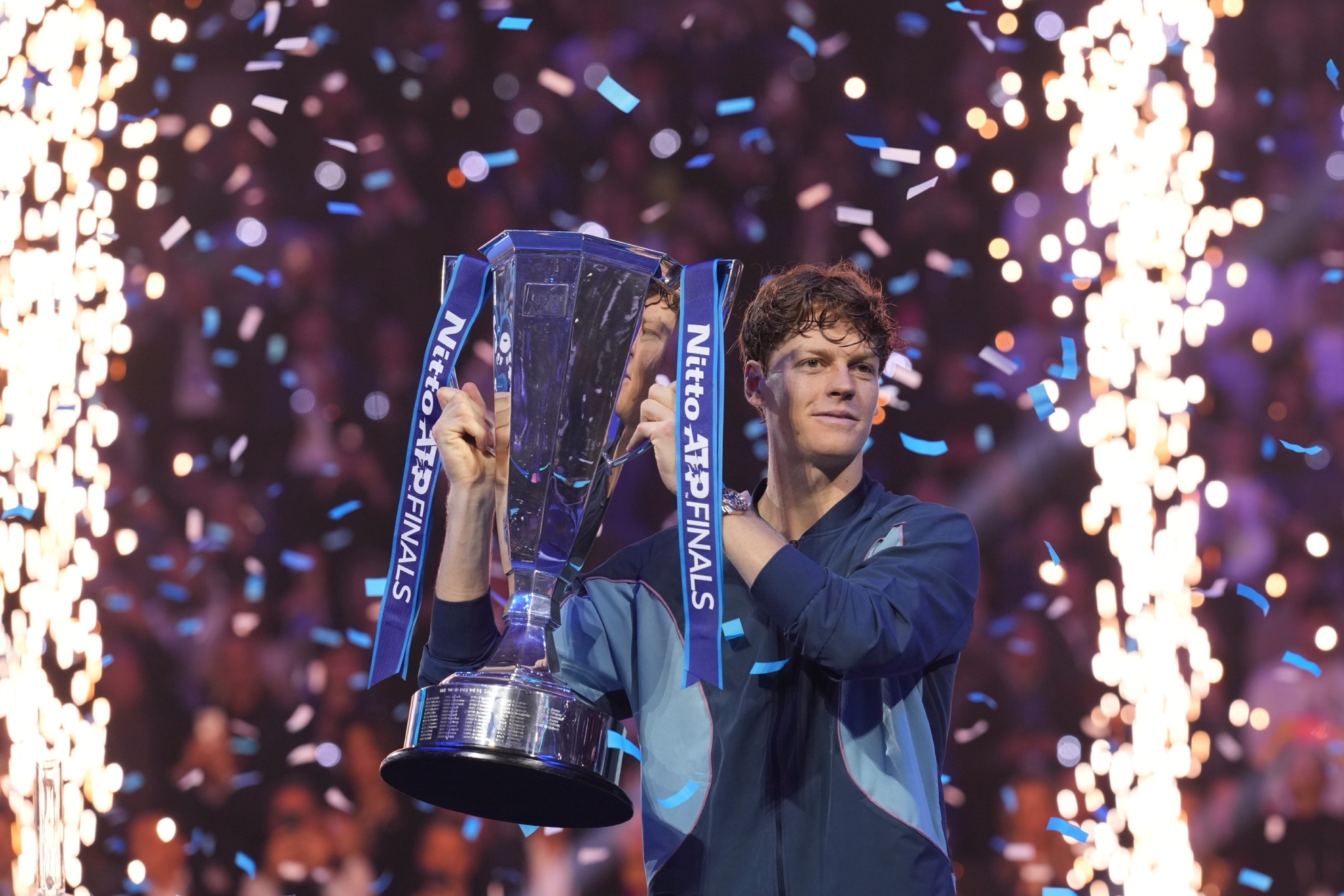 Italy's Jannik Sinner holds the trophy after winning the final match of the ATP World Tour Finals against Taylor Fritz of the United States at the Inalpi Arena, in Turin, Italy, Sunday, Nov. 17, 2024.
