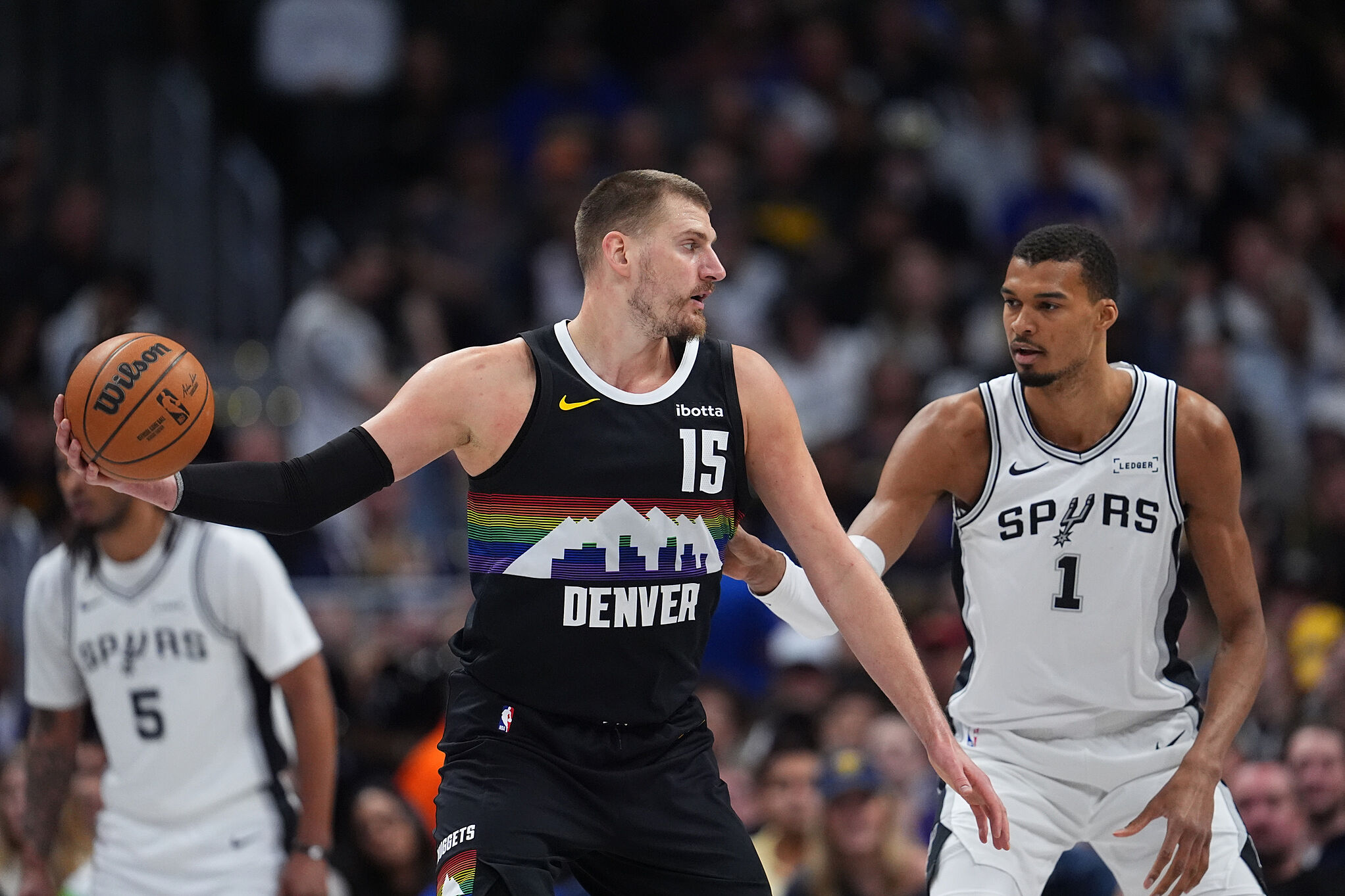 Denver Nuggets center Nikola Joki (15) and San Antonio Spurs center Victor Wembanyama (1) during an NBA basketball game