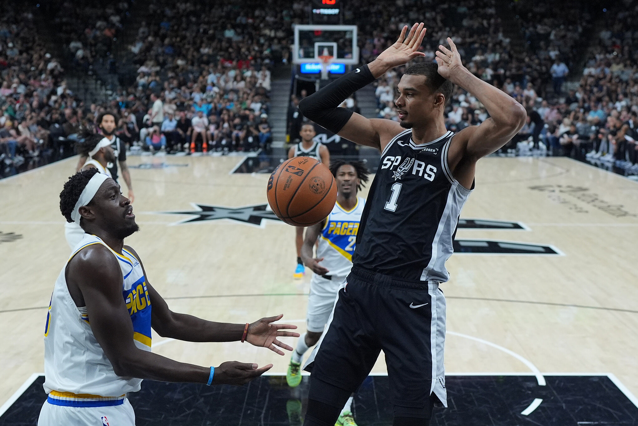 San Antonio Spurs forward Victor Wembanyama (1) scores over Indiana Pacers forward Pascal Siakam (43) during an NBA game in San Antonio