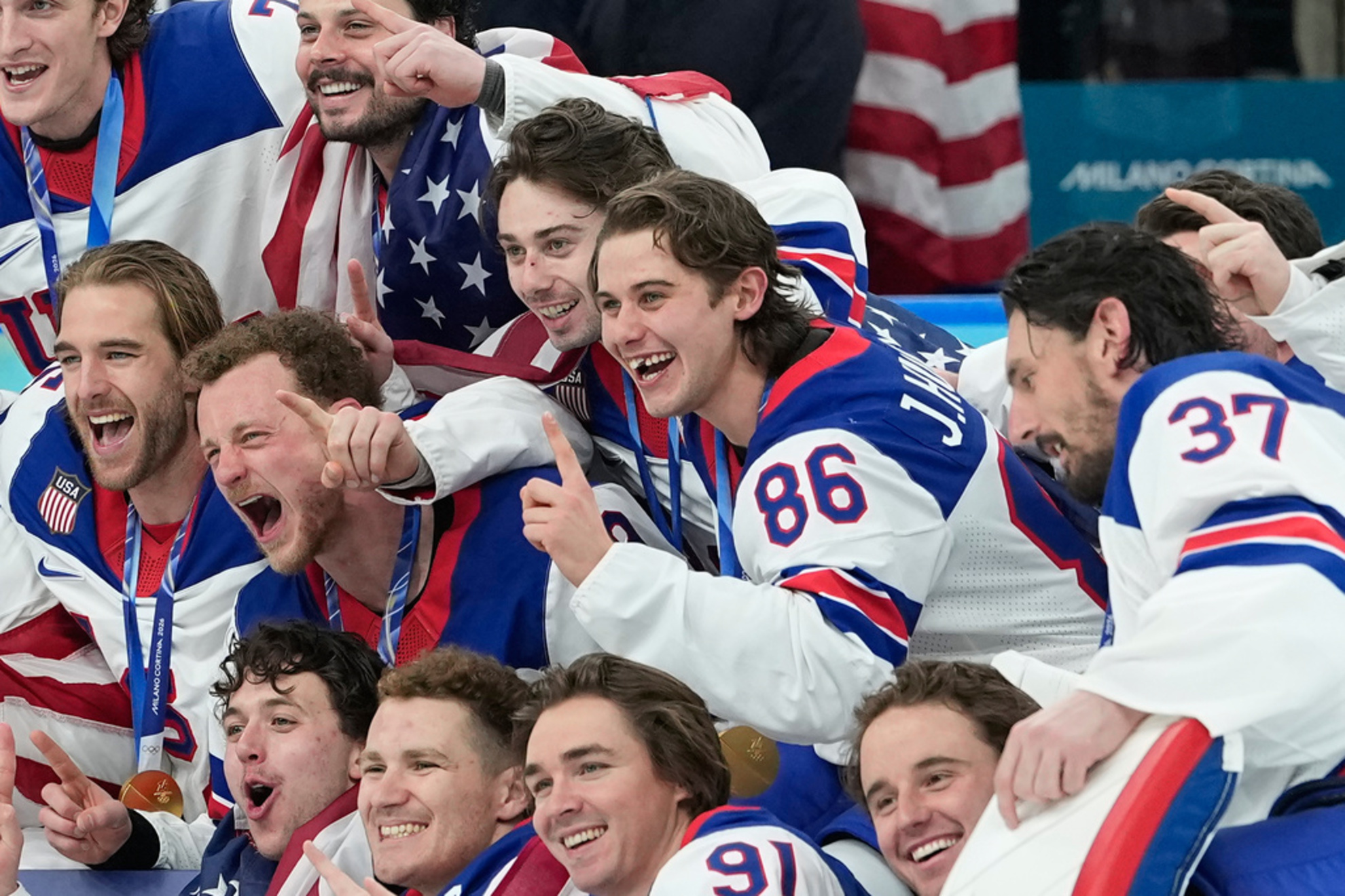 United States' Jack Hughes (86) poses with teammates