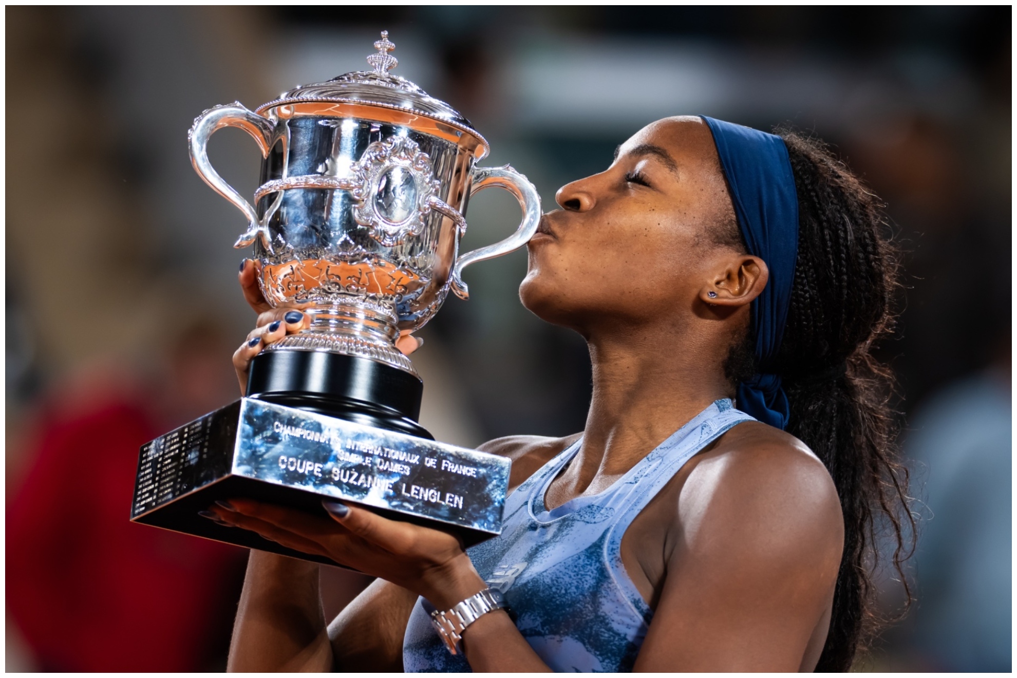 Coco Gauff kissing the cup after winning her French Open trophy