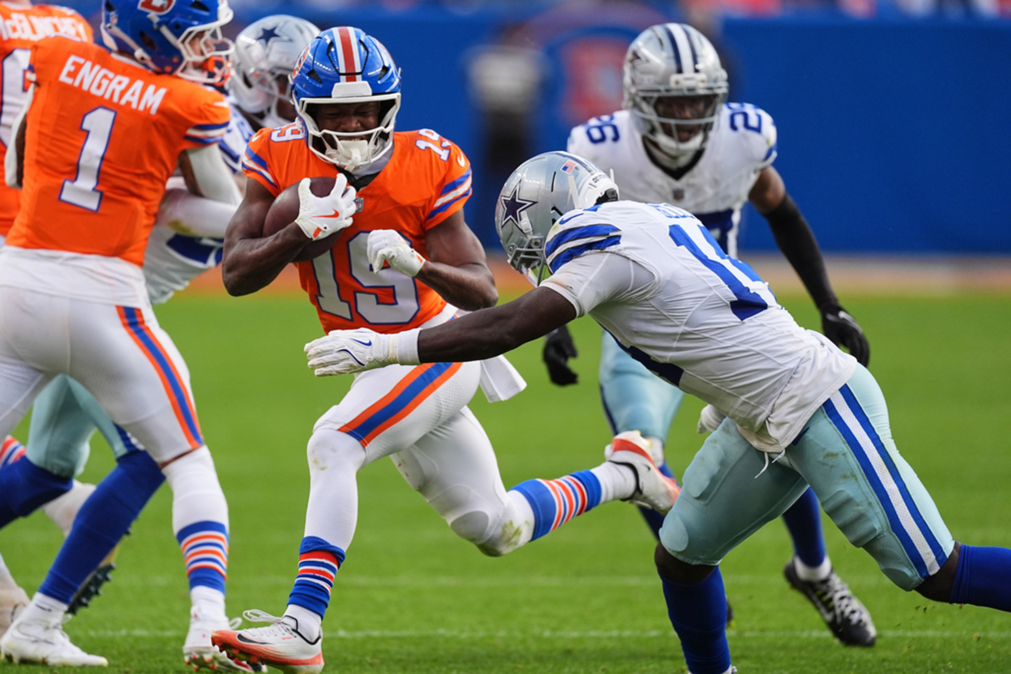 Denver Broncos wide receiver Marvin Mims Jr. attempts to get past Dallas Cowboys safety Markquese Bell