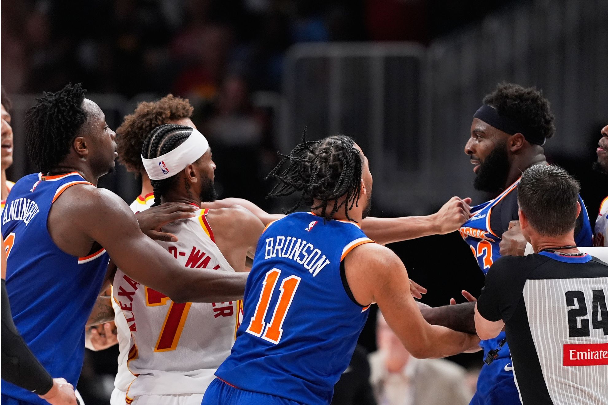 Mitchell Robinson is restrained during a chaotic moment in Game 6