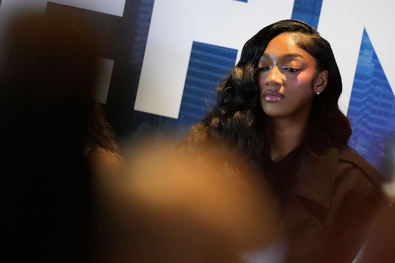 Angel Reese listens with laughs and knowing glances as her new teammates share their comments