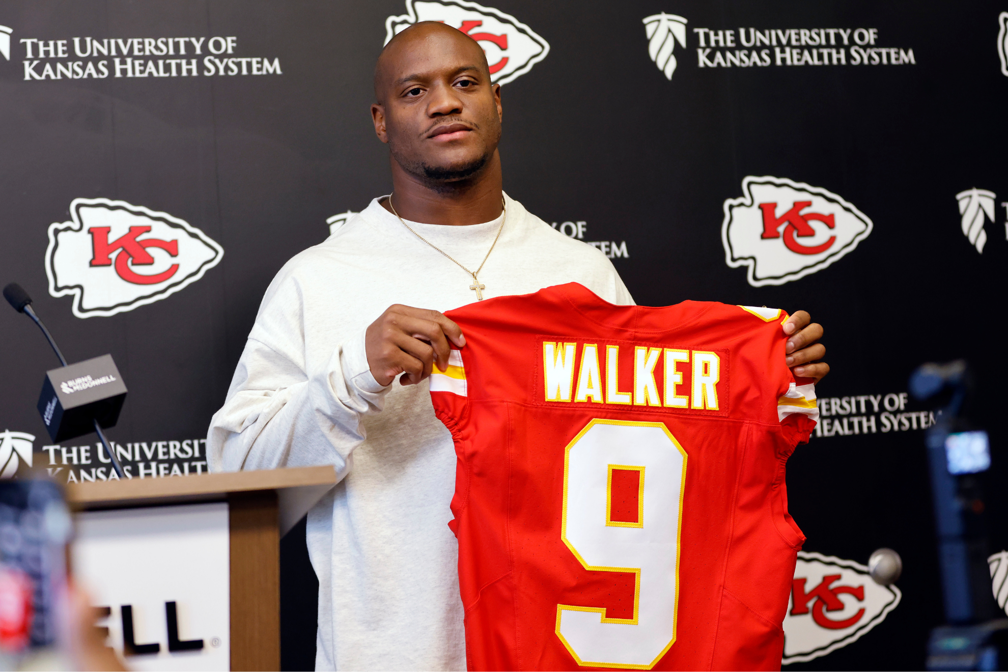 Kenneth Walker III shows off his Kansas City Chiefs jersey after being announced as the team's free agent signing.