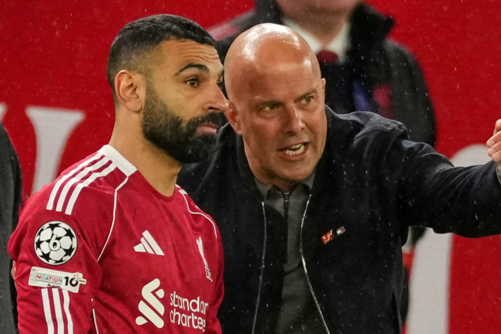 Mohamed Salah takes directions from Liverpool manager Arne Slot during a Champions League game.