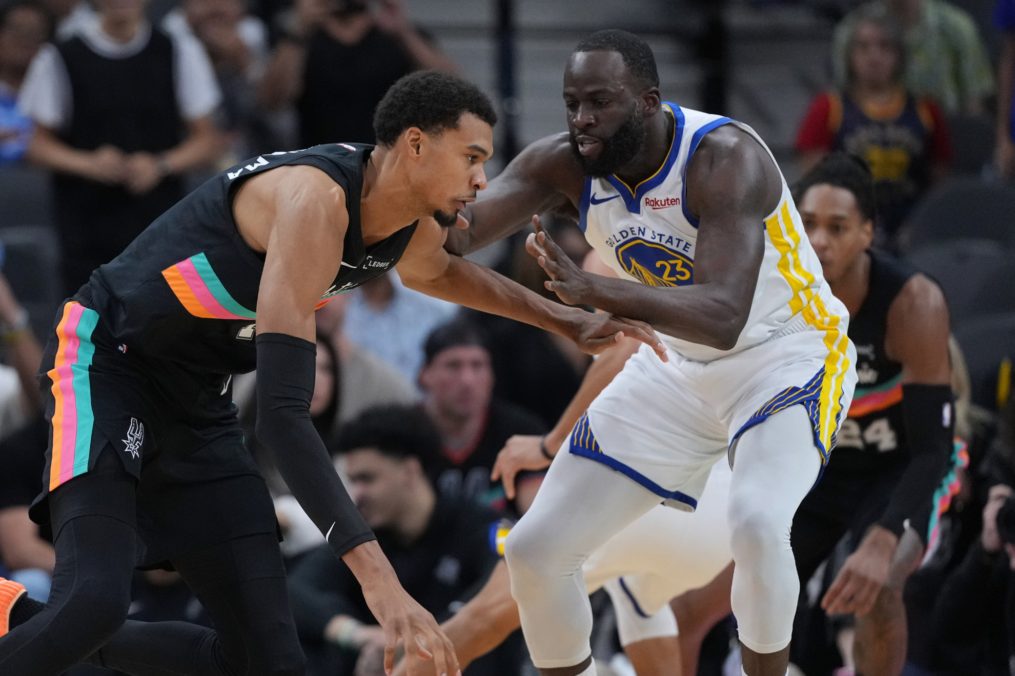 Draymond Green guards Victor Wembanyama during a San Antonio Spurs vs. Golden State Warriors game.