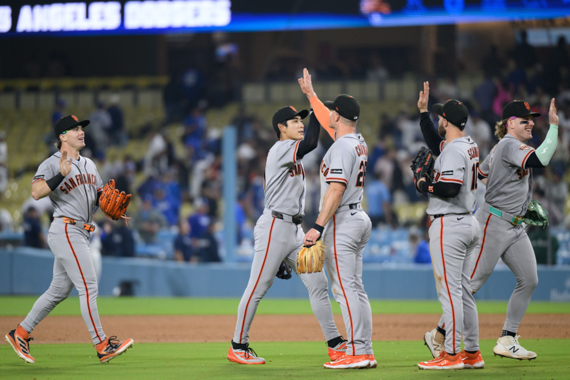 San Francisco Giants players celebrate the team's win over the Los Angeles Dodgers in a baseball game in Los Angeles, Monday, May 11, 2026. (AP Photo/Kyusung Gong)
