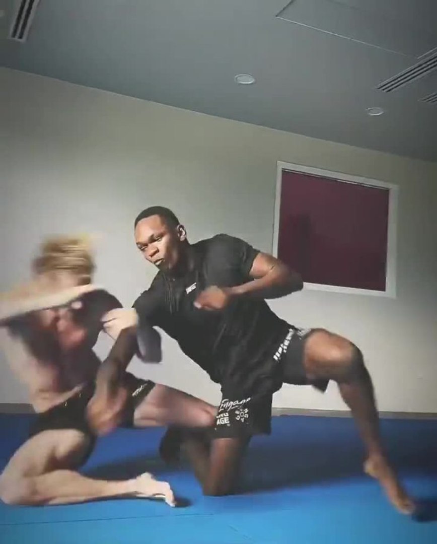 Logan Paul and Israel Adesanya wrestling